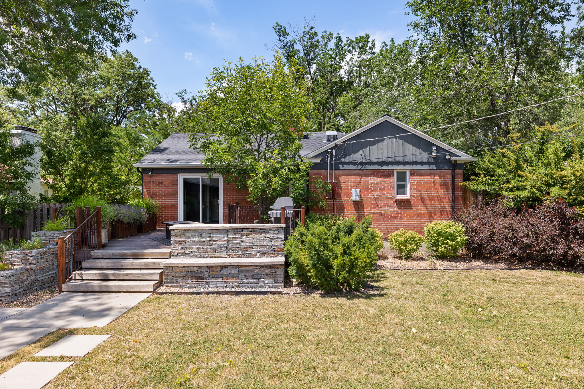 Red brick exterior with a dark grey gable roof