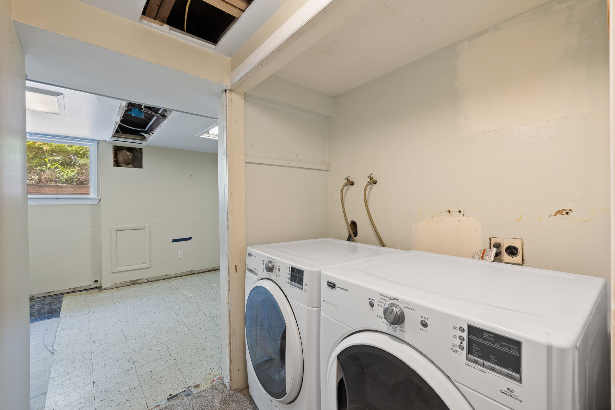 Utility area featuring existing washer and dryer connections