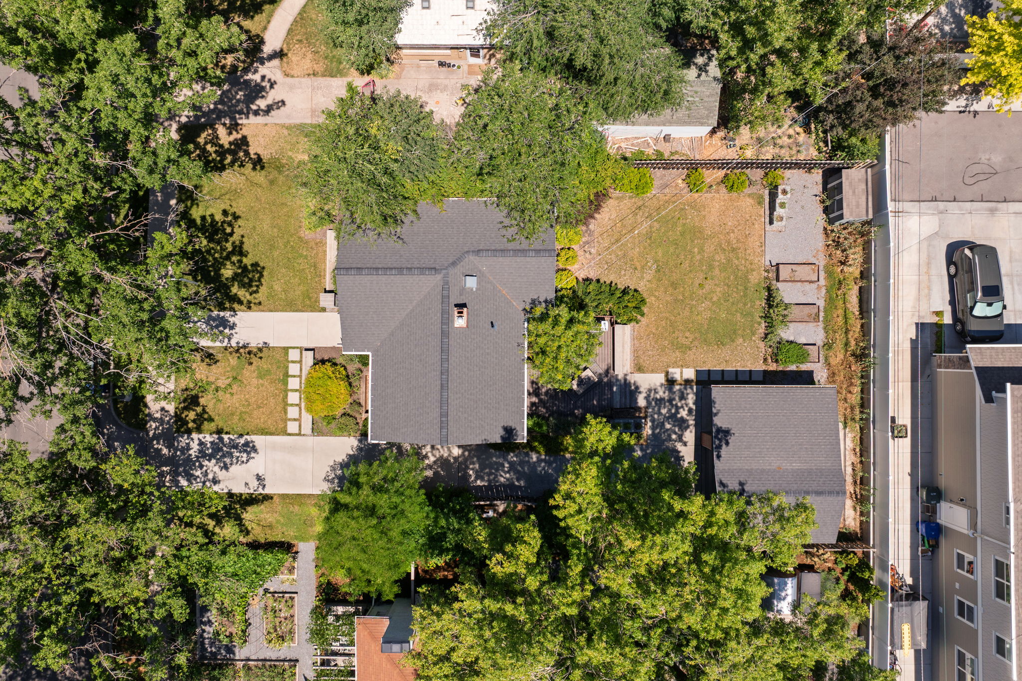 Detached single-family residence featuring a dark gray shingle roof and a prominent chimney