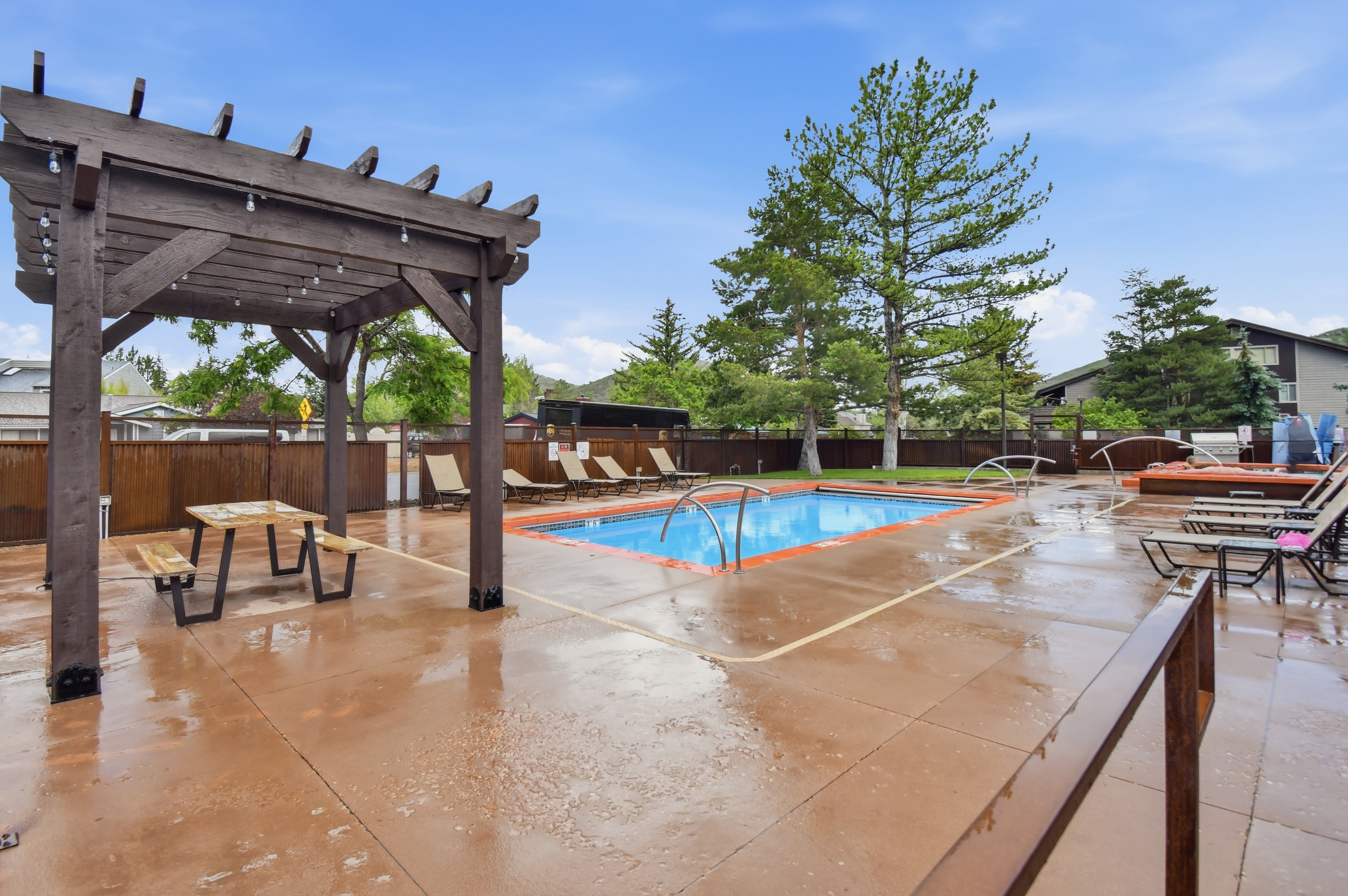 Outdoor amenity area featuring a rectangular pool with integrated spa