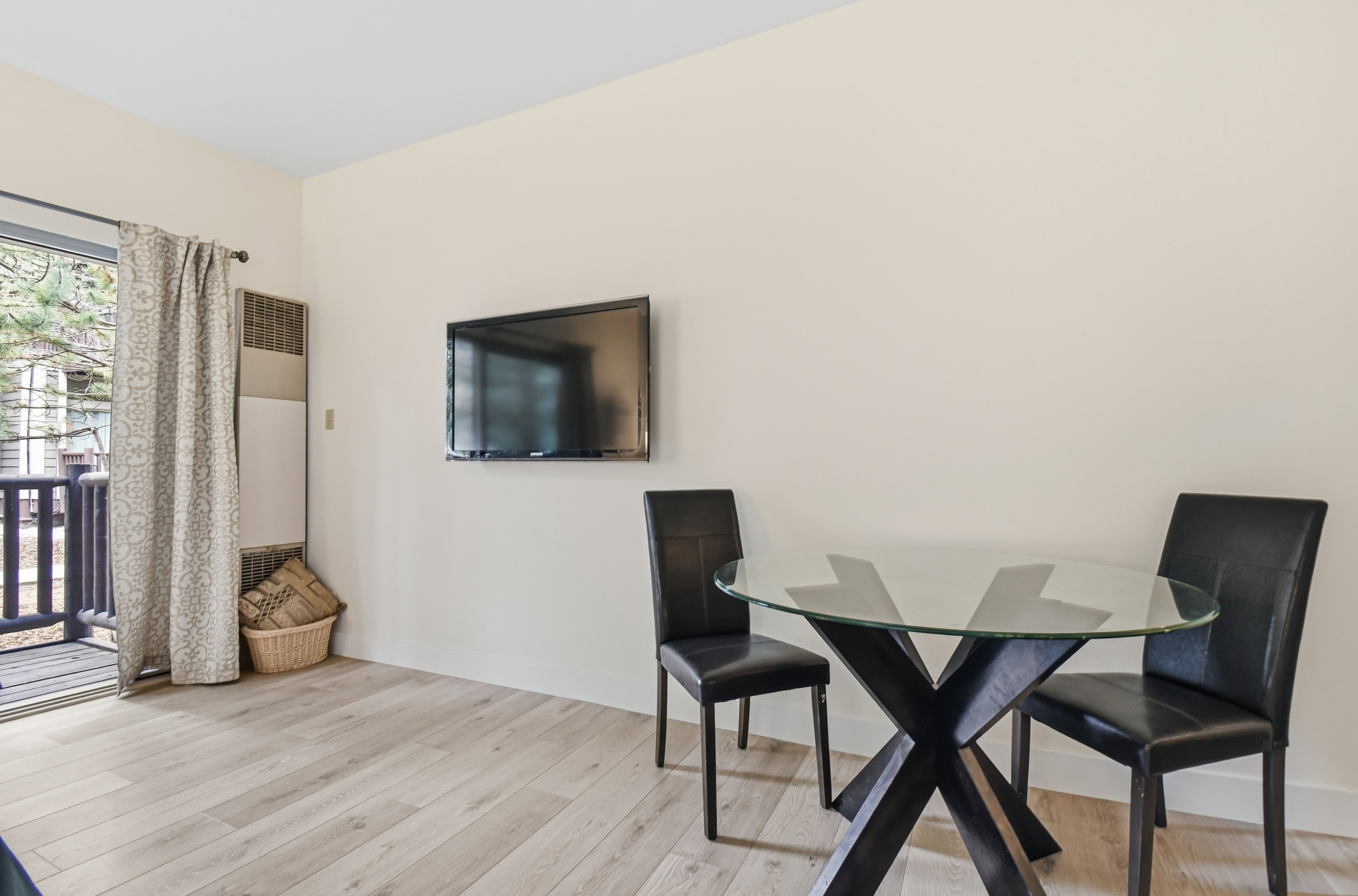 Light wood-finish flooring complements neutral wall tones