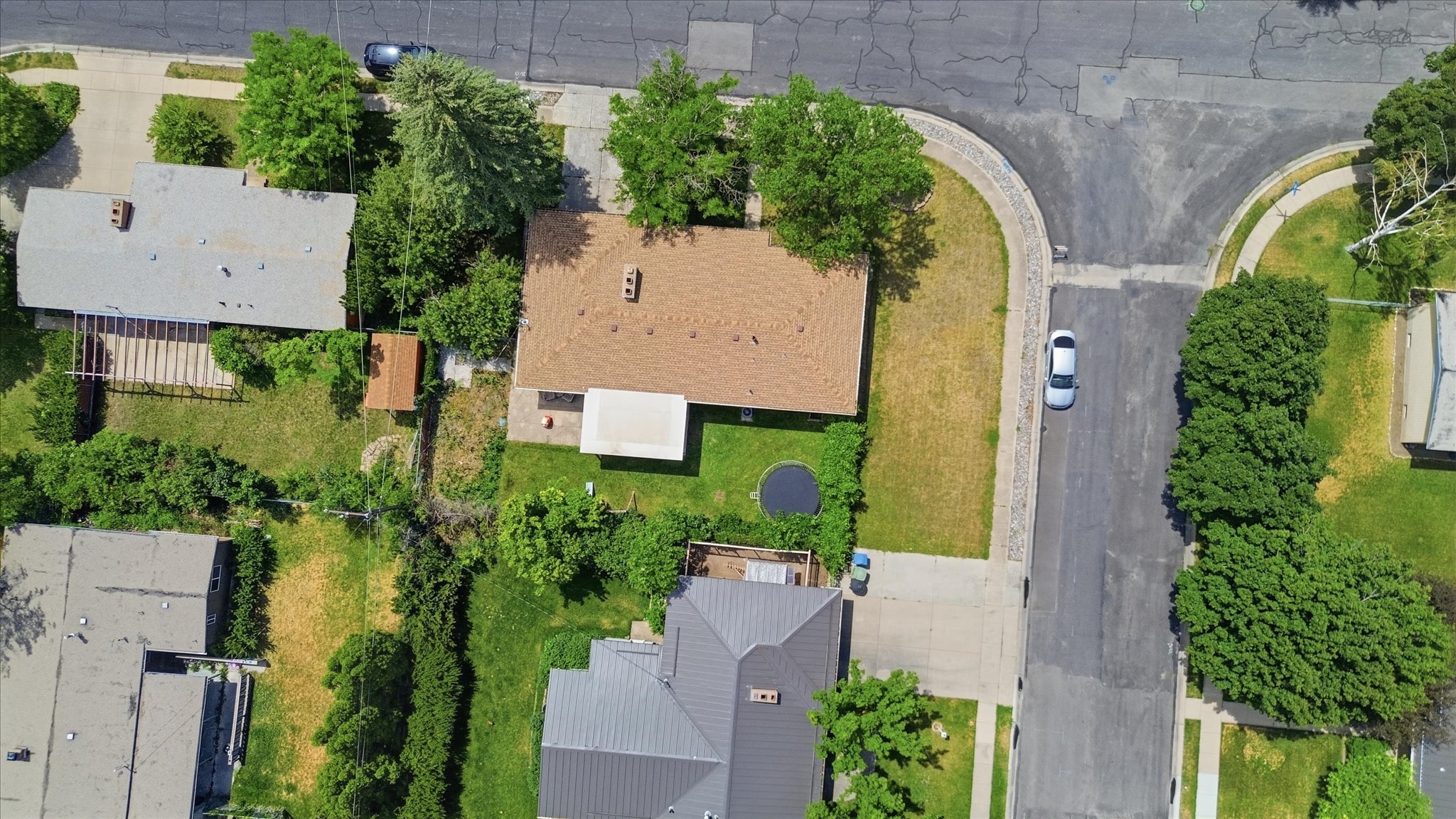 Property featuring a brown shingle roof, a rectangular footprint, and a front yard with a partial curb
