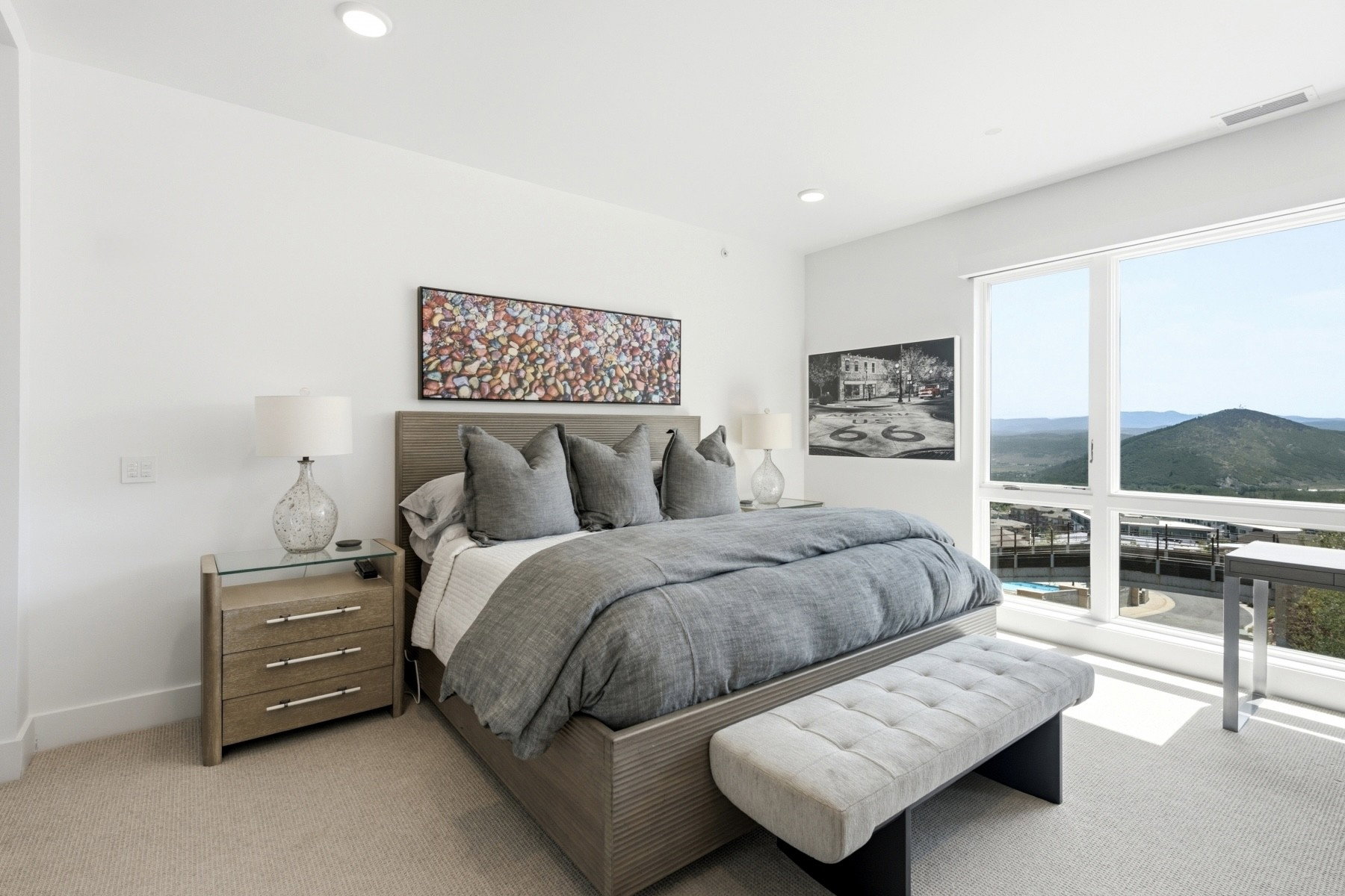 Spacious bedroom featuring expansive windows, recessed lighting, and light-colored carpeting