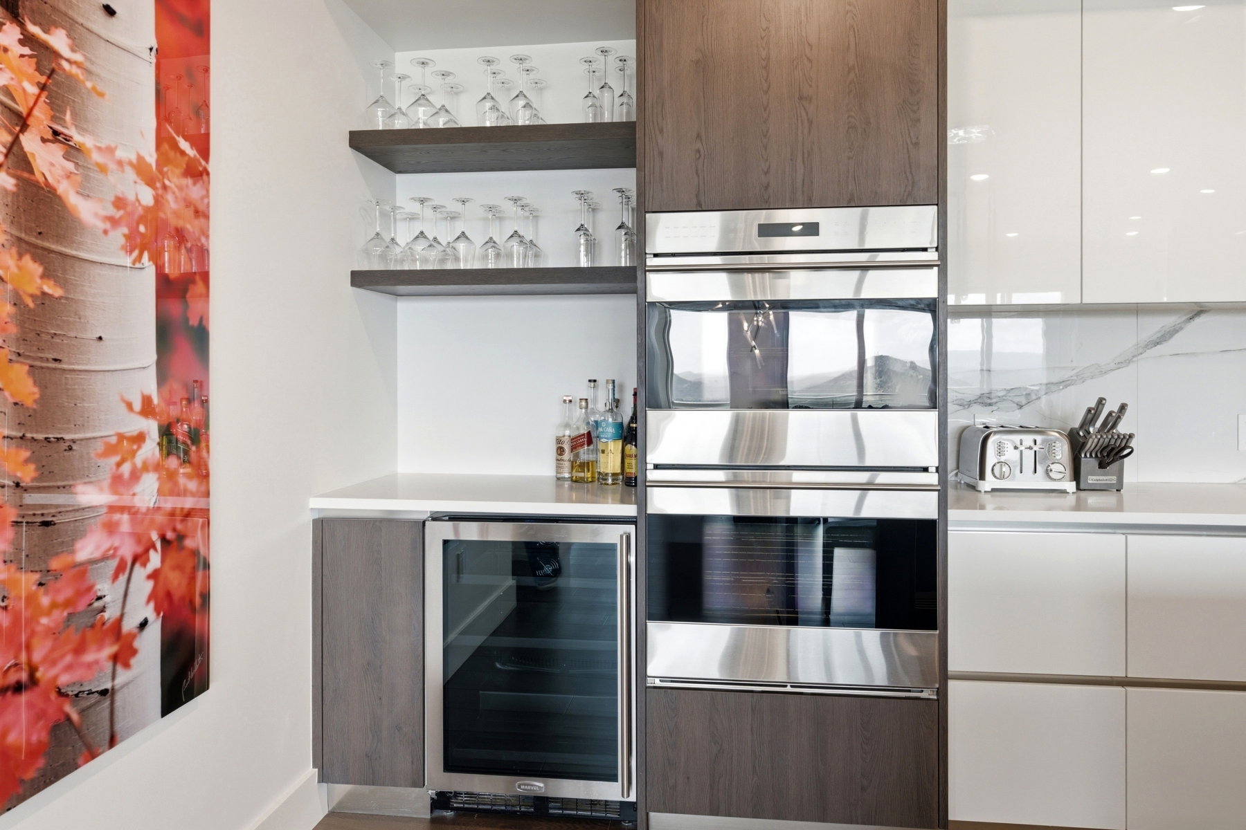 Built-in stainless steel double ovens integrated into dark wood-finish cabinetry