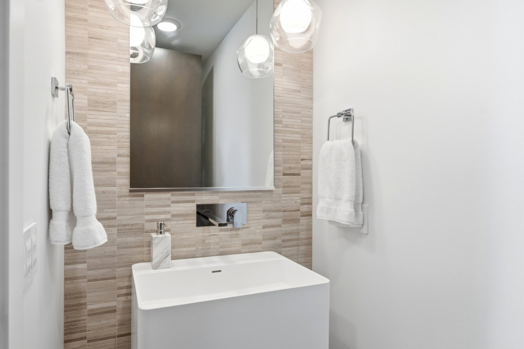 Floating vanity with integrated sink, wall-mounted faucet, and rectangular mirror