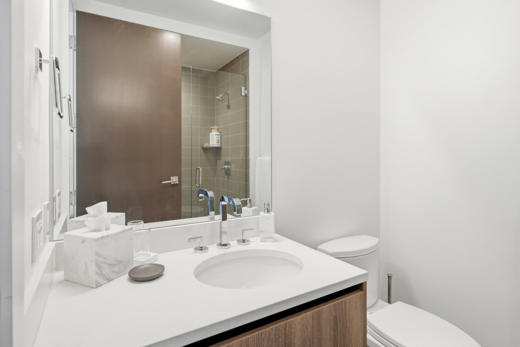 Modern bathroom featuring a contemporary vanity with a white countertop and integrated sink