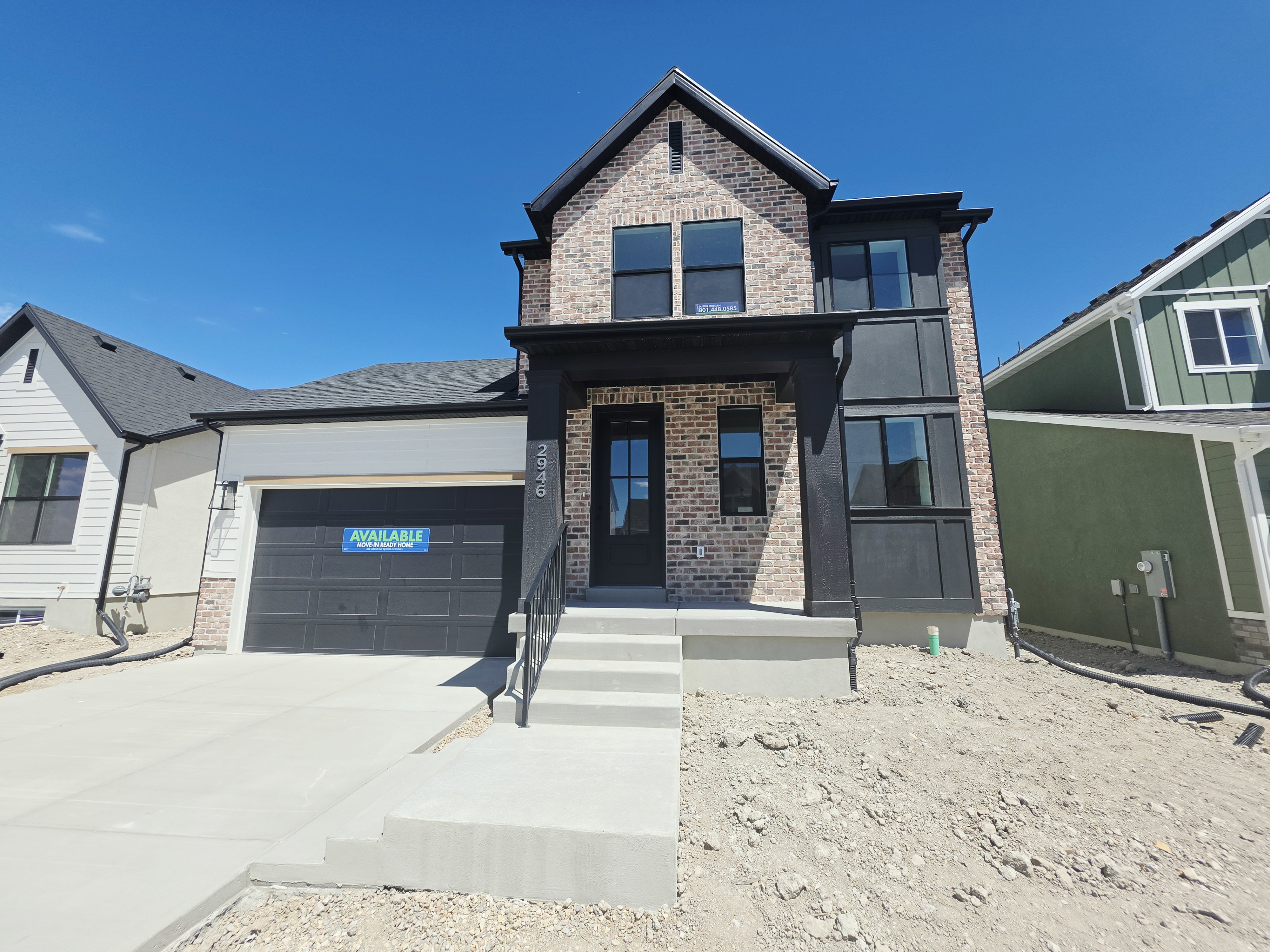 Modern two-story residence featuring a brick facade and dark trim accents