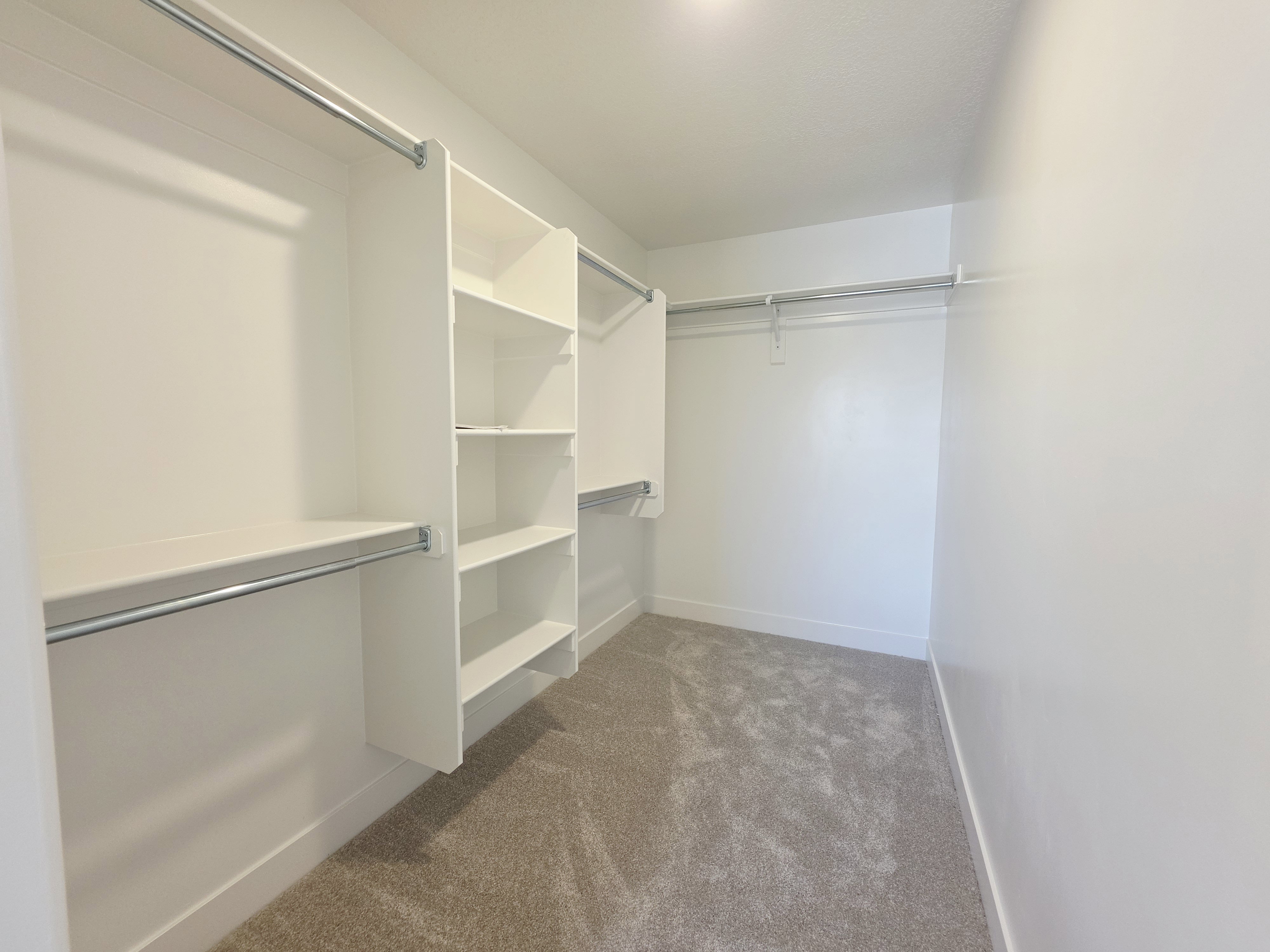 Custom closet system featuring shelving and hanging rods