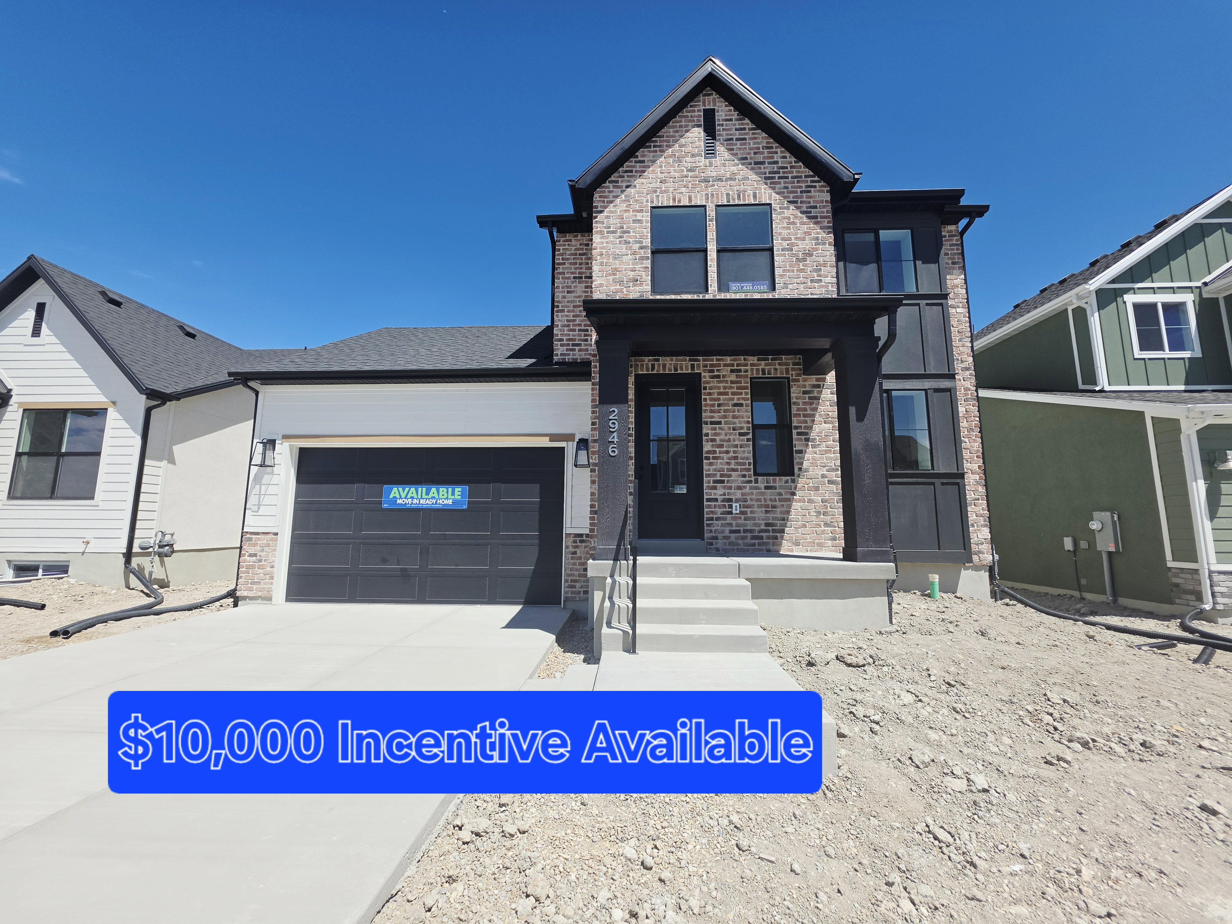 Contemporary exterior featuring brick and vertical siding accents, a prominent covered entry, and an attached two-car garage