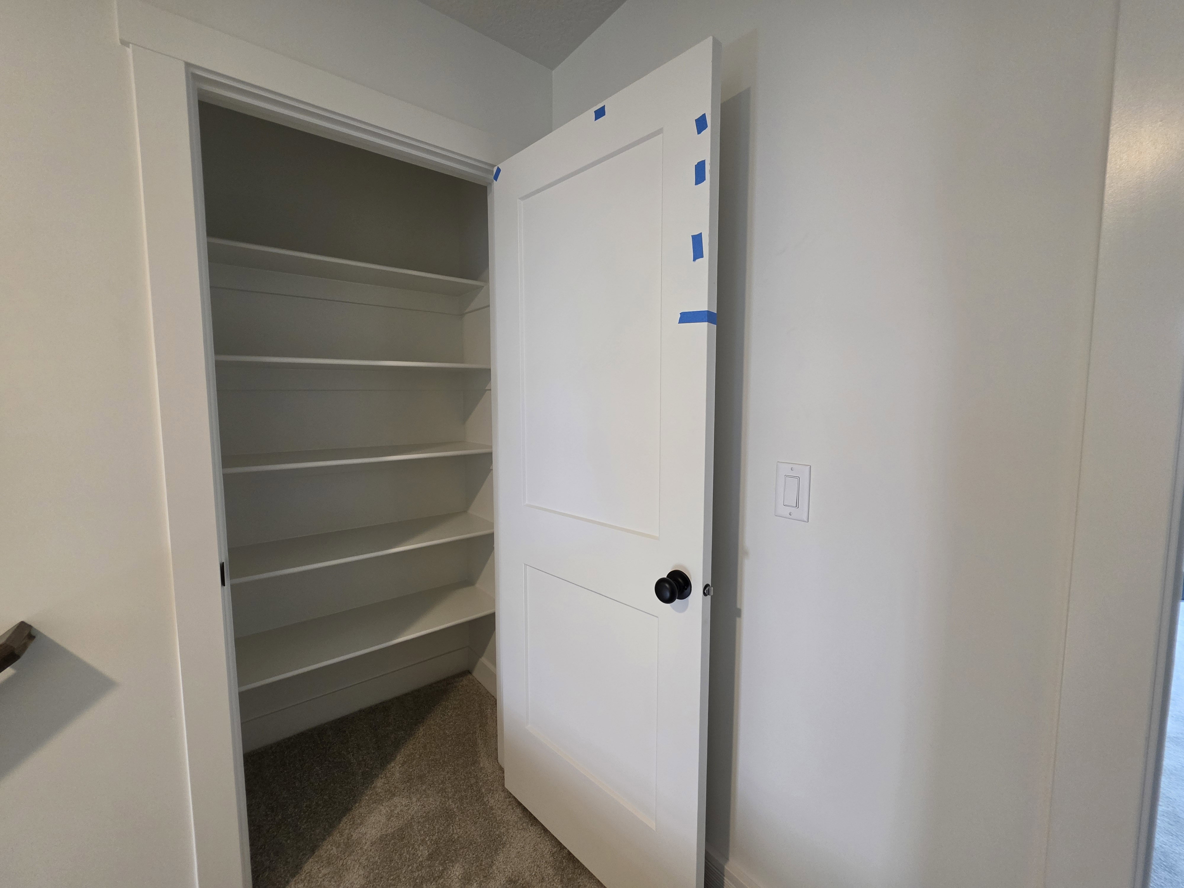 White pantry with multiple integrated shelves