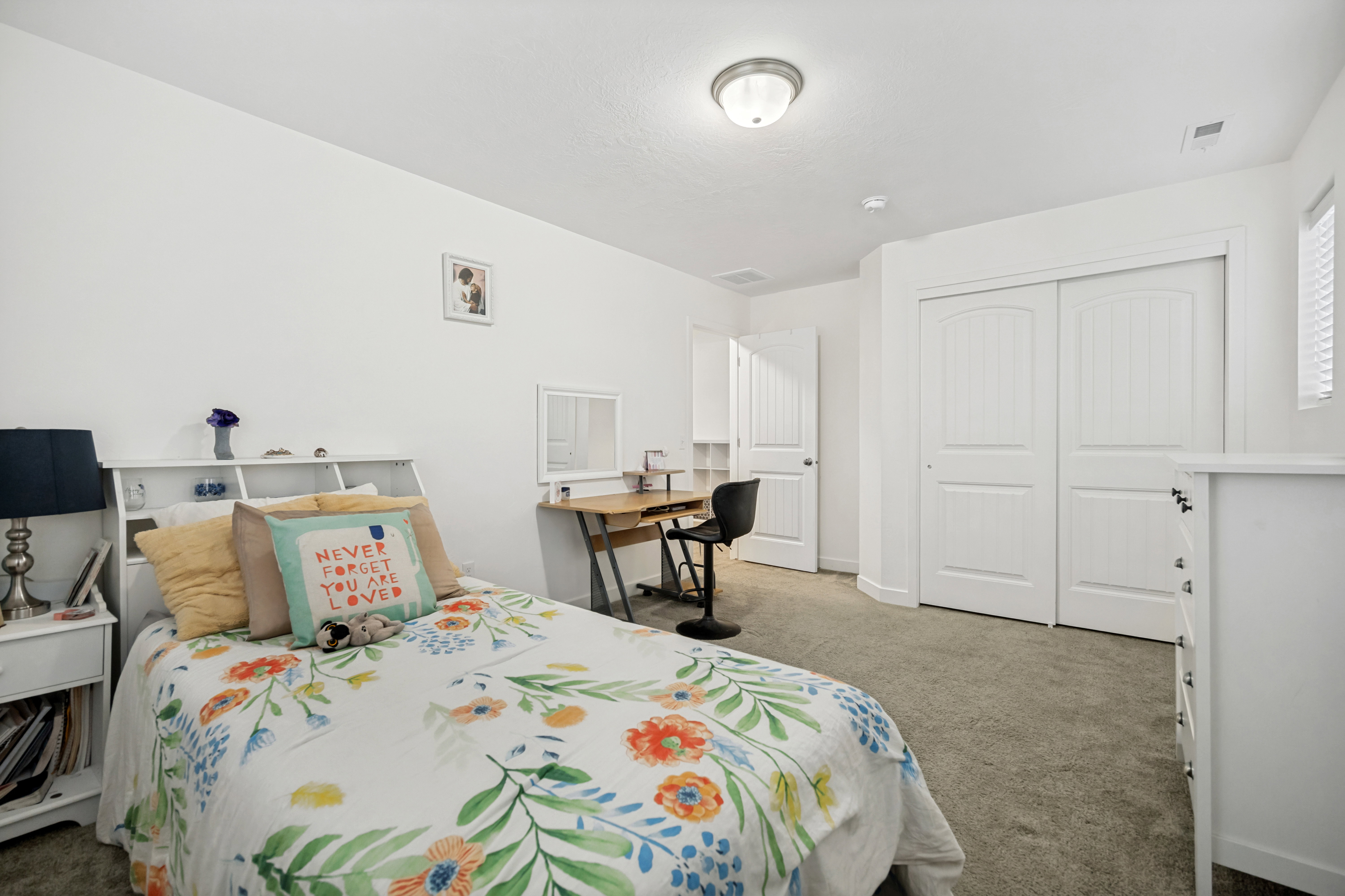 Carpeted room with a ceiling-mounted light fixture