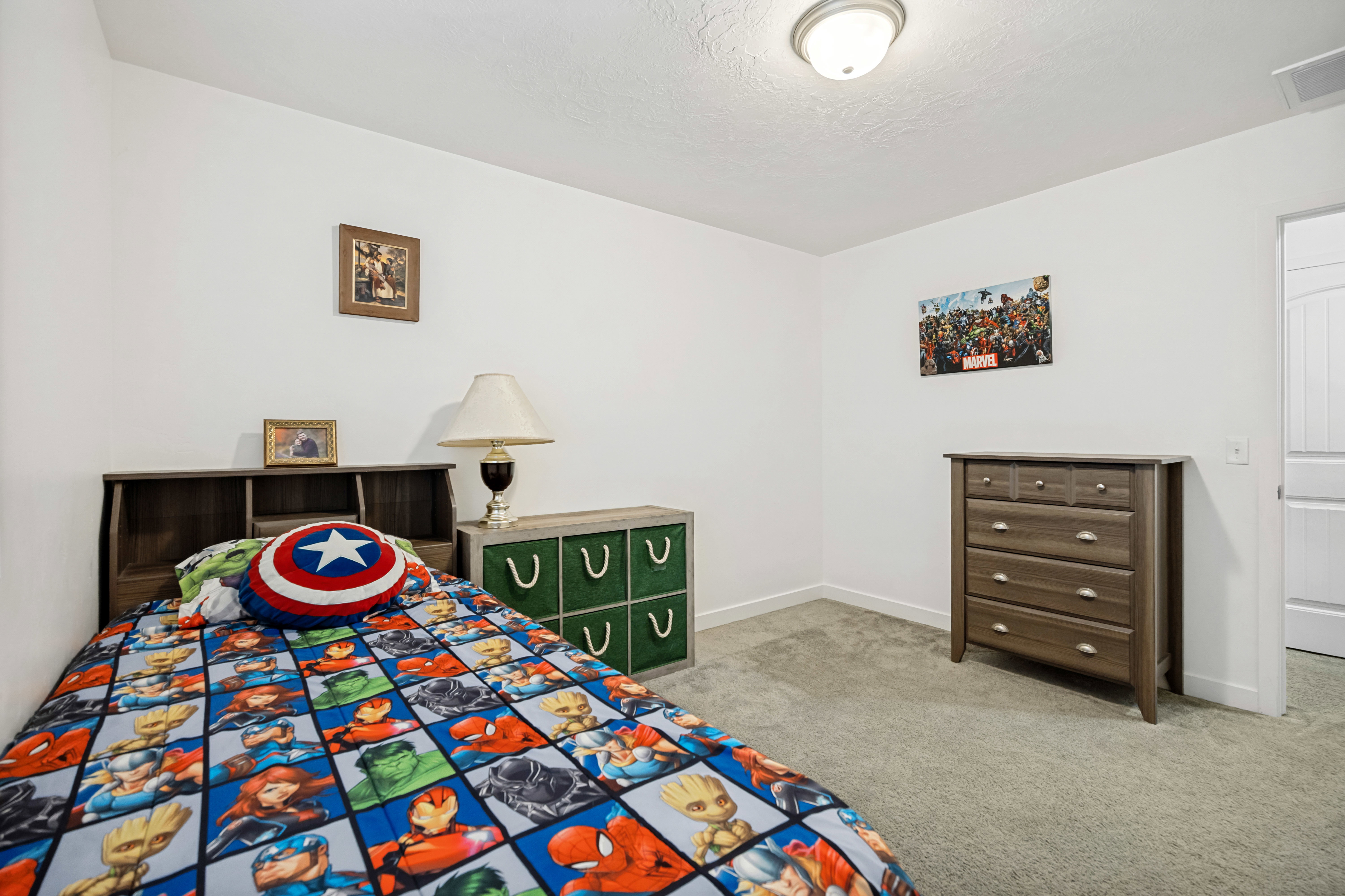 Carpeted interior room featuring bright white walls, white trim, and a white ceiling with a flush-mount light fixture