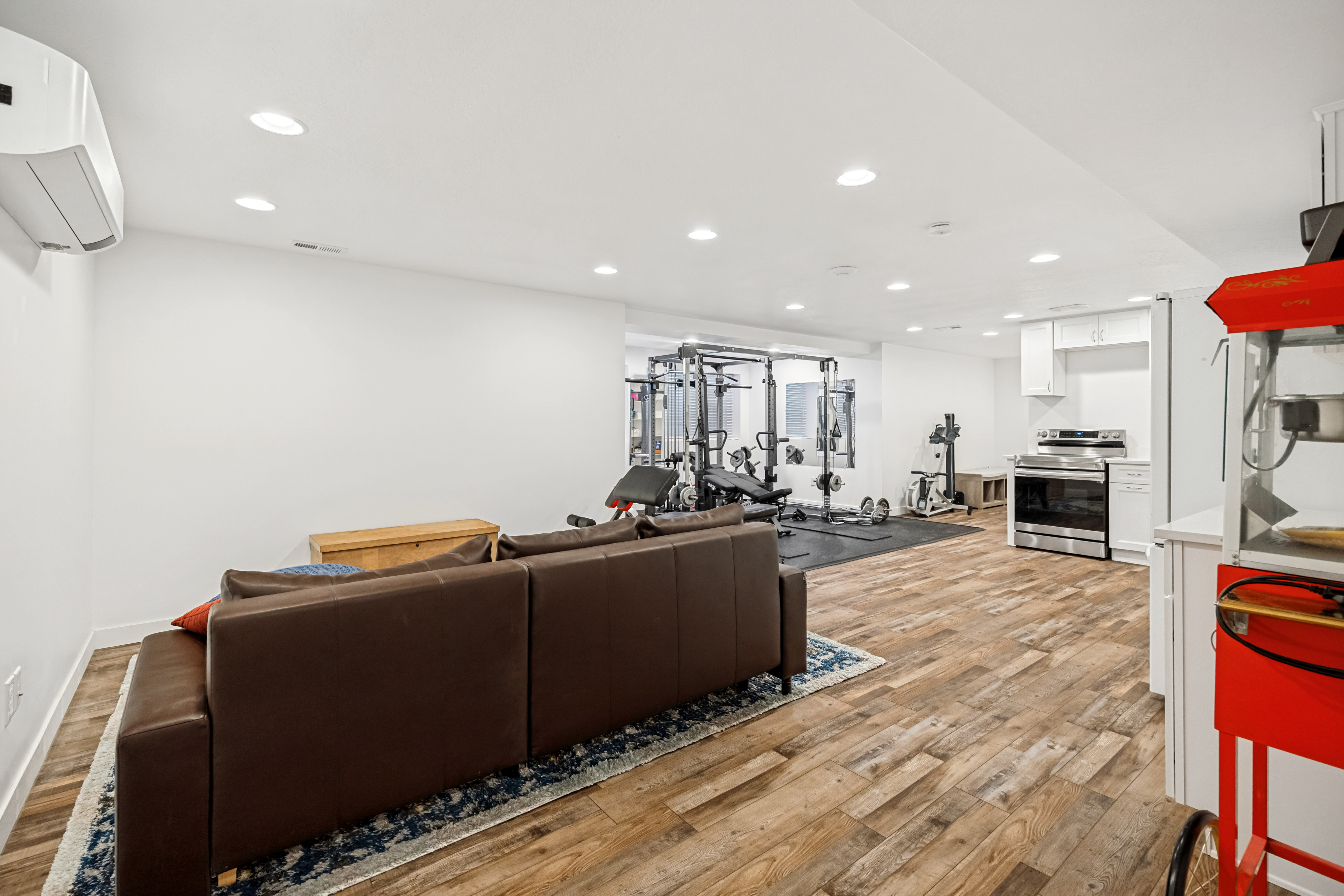 Open-concept recreation area featuring wood-finish flooring and recessed lighting
