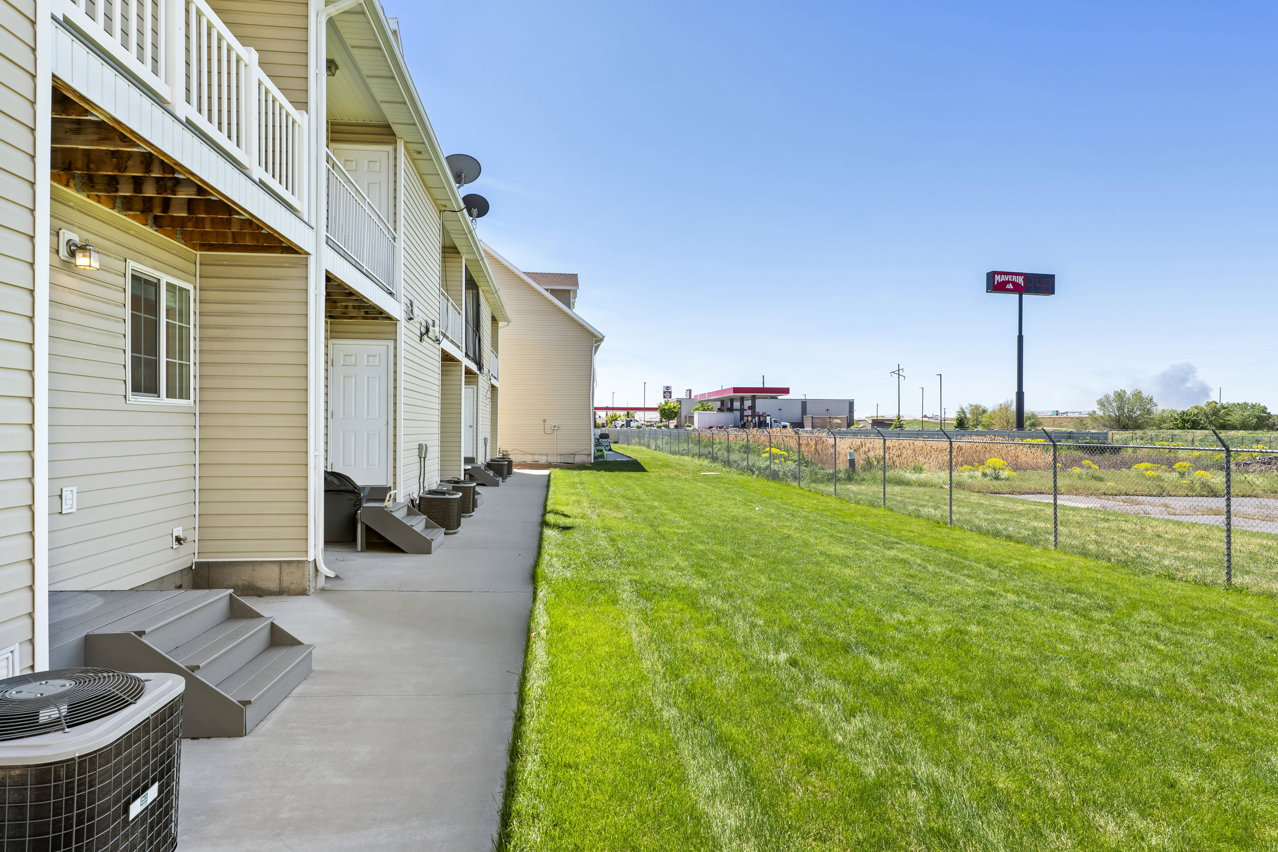 Exterior siding with multiple balconies and ground-level patios