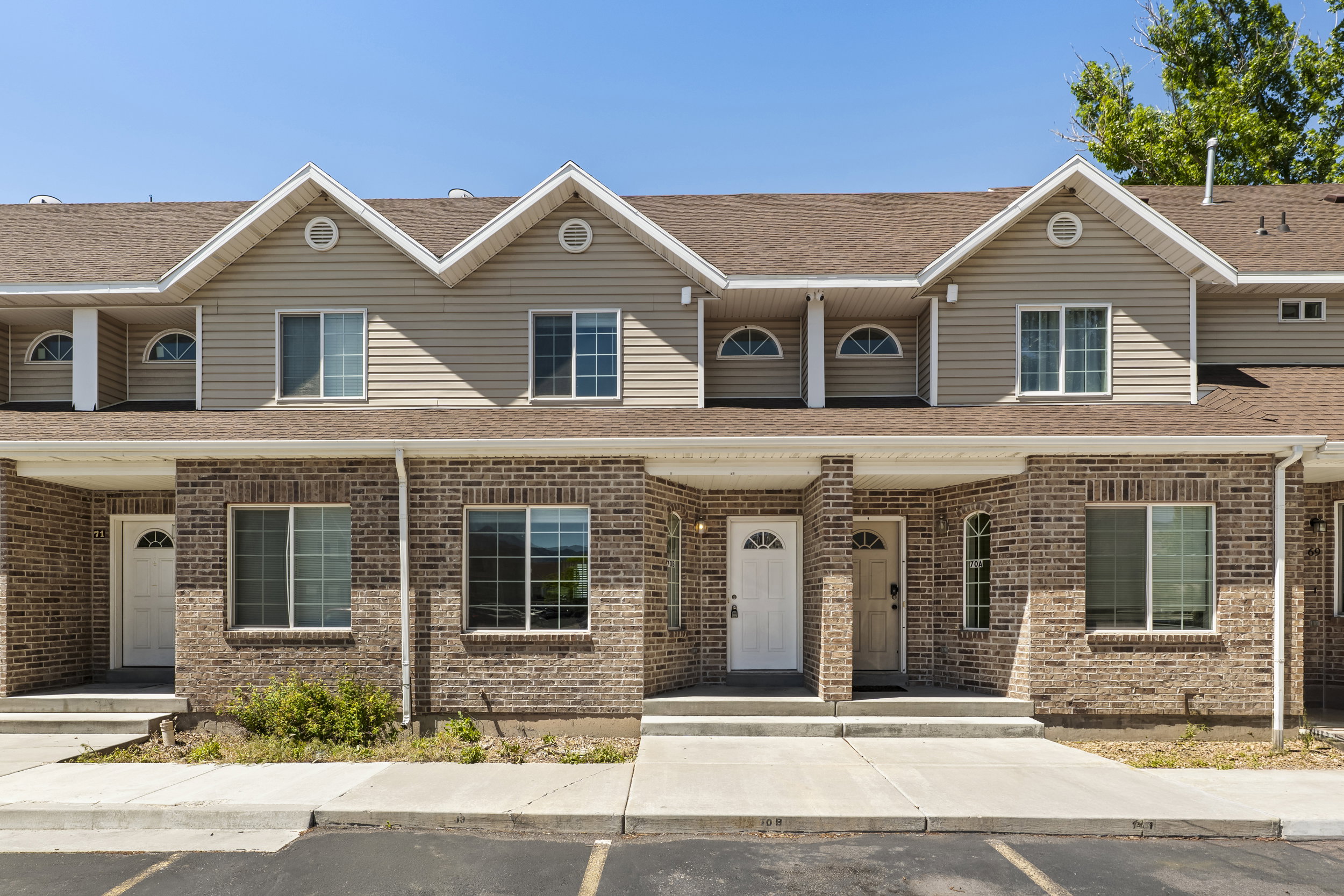 Townhome facade featuring brick and siding construction