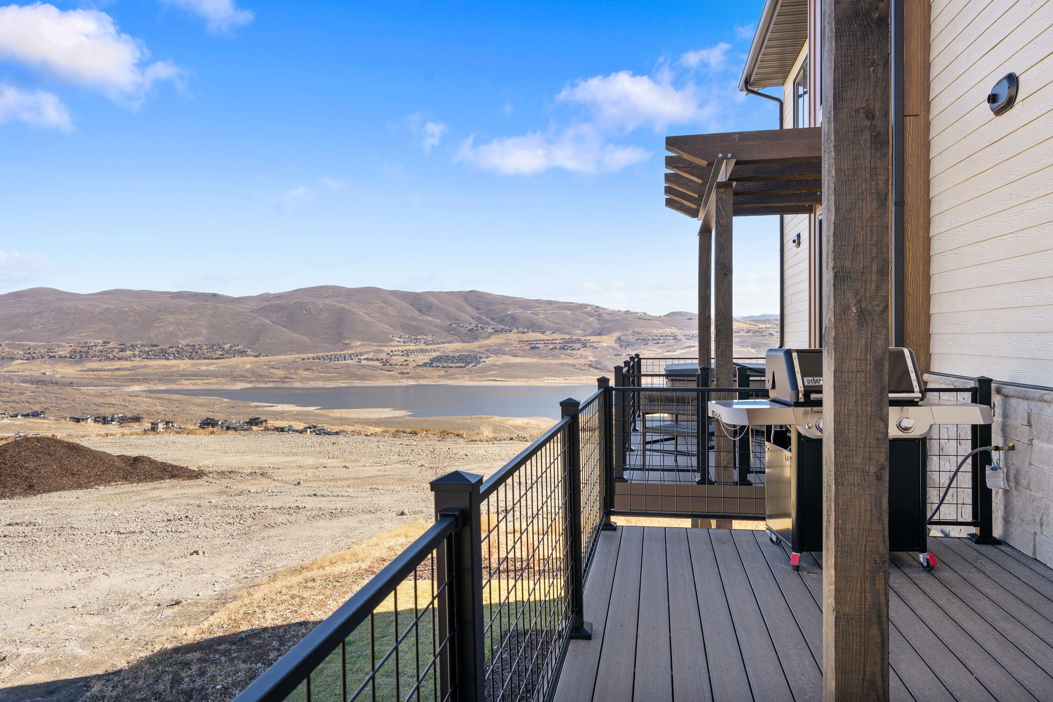 Expansive outdoor deck featuring composite decking and black metal railings