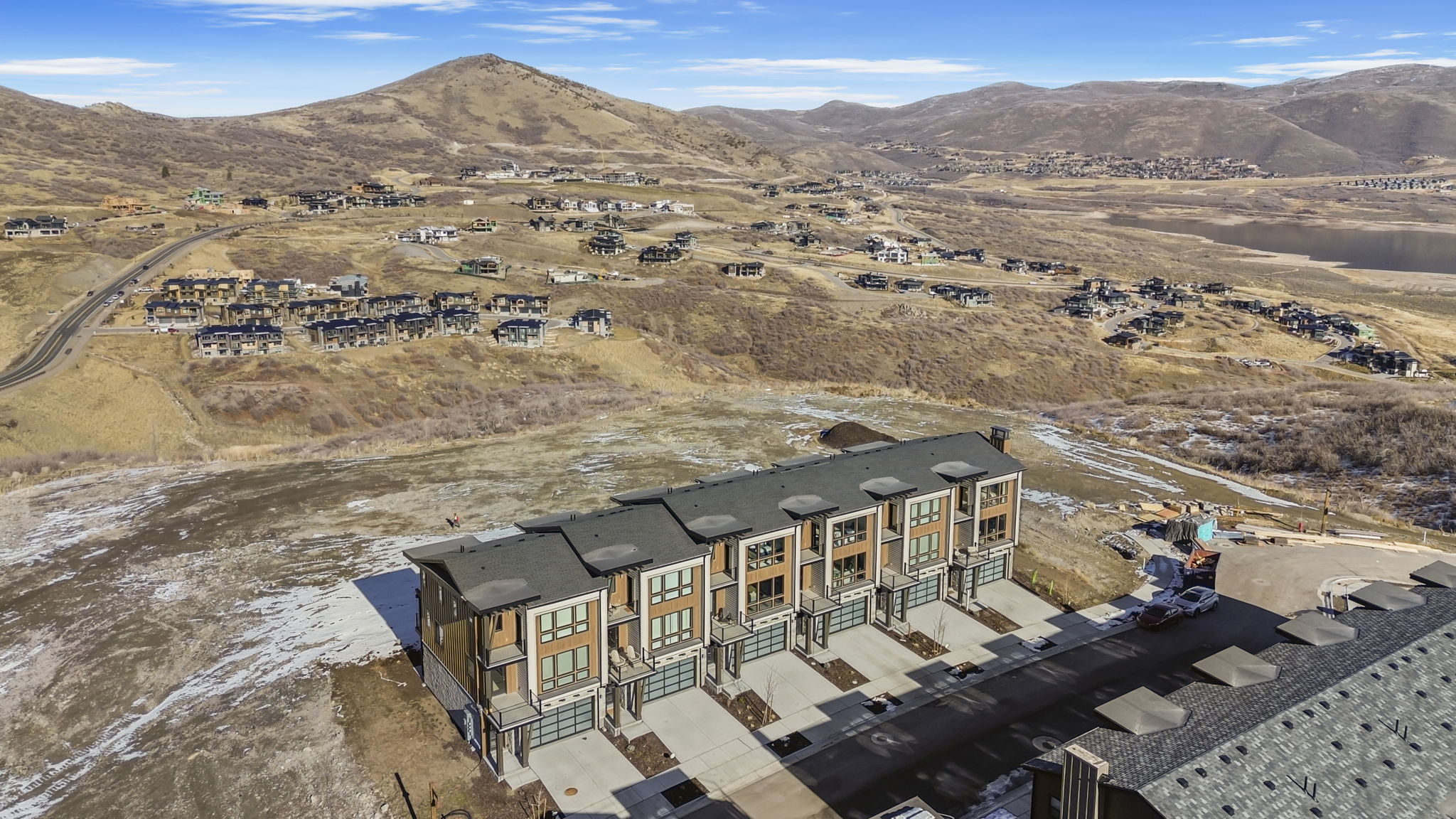 Modern townhome development with contemporary architecture, individual garages, and private balconies