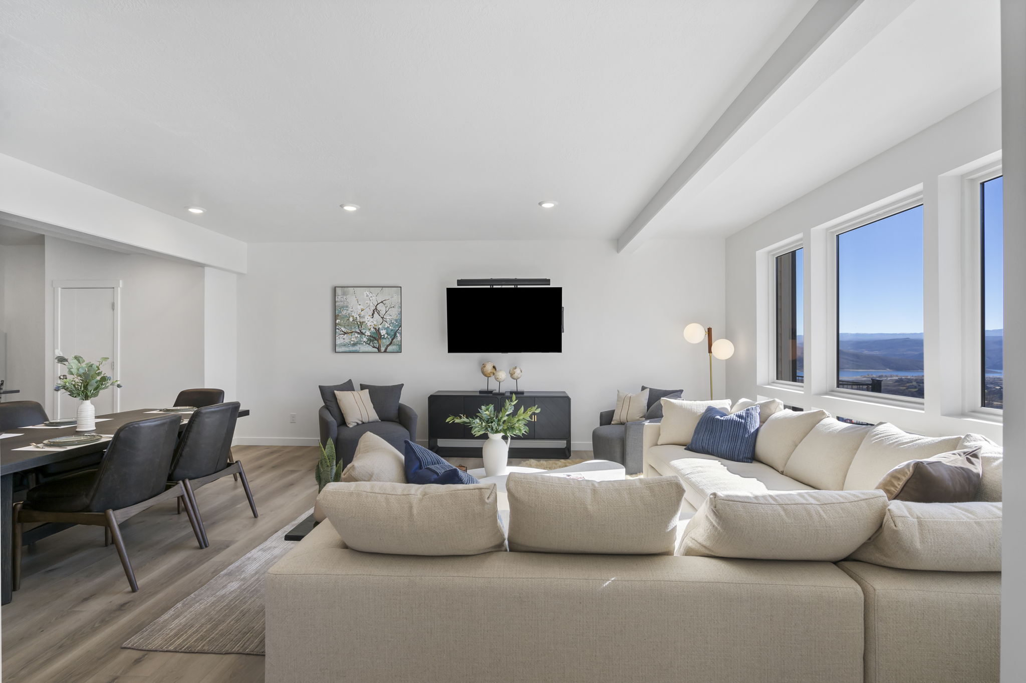 Open-concept living space featuring wood-finish flooring and recessed lighting