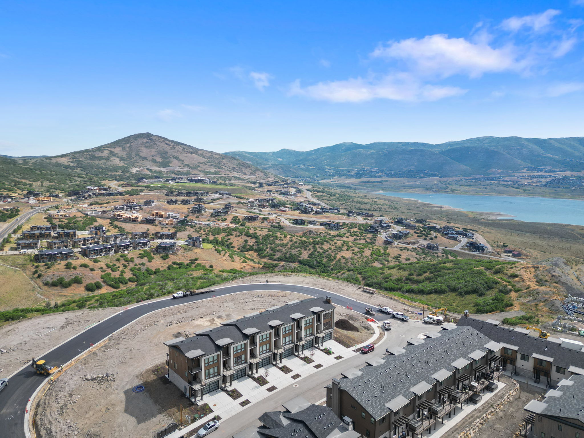 Aerial perspective showcasing modern townhomes with mountain and lake scenery