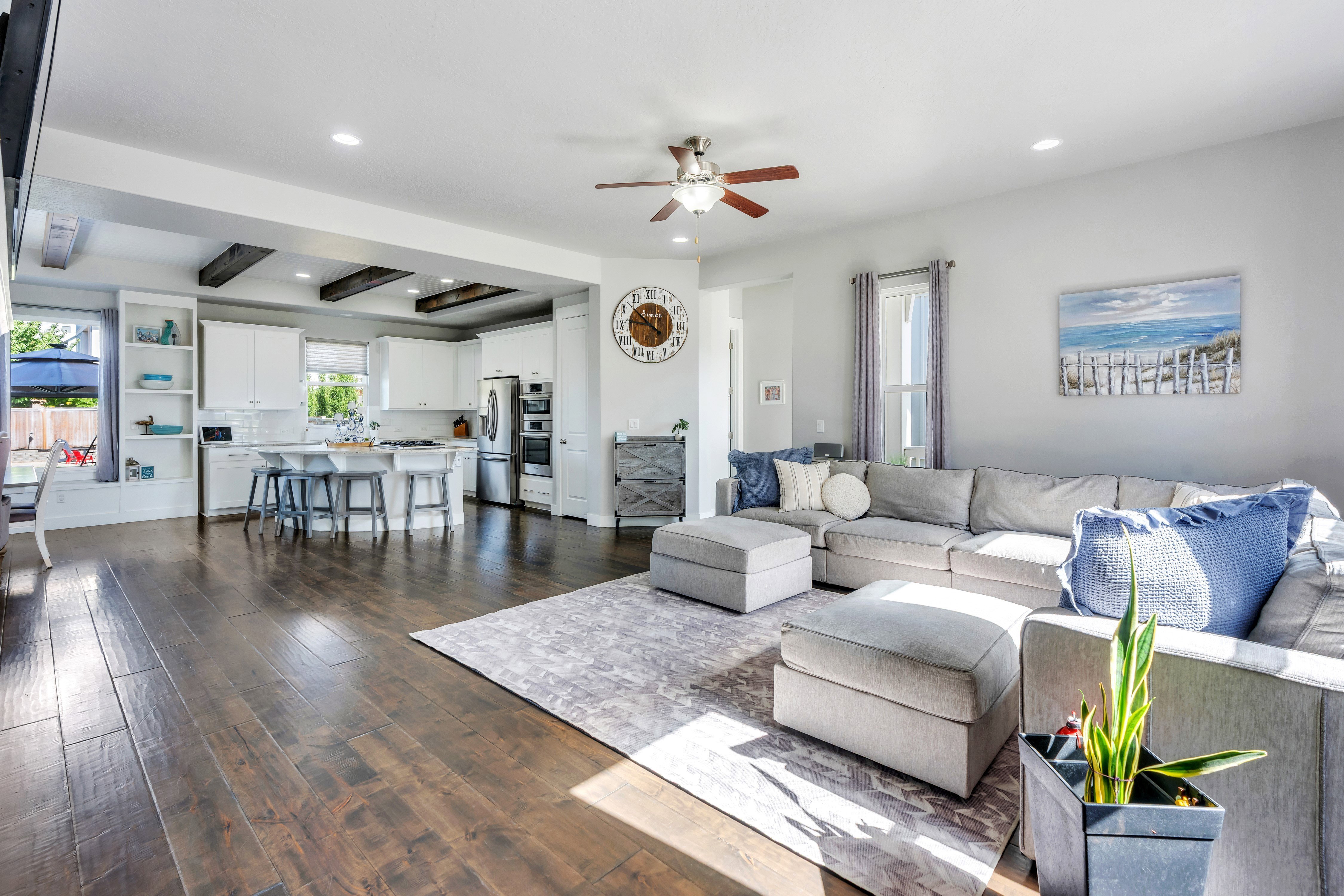 Open-concept living space featuring wood-finish flooring, recessed lighting, and a ceiling fan