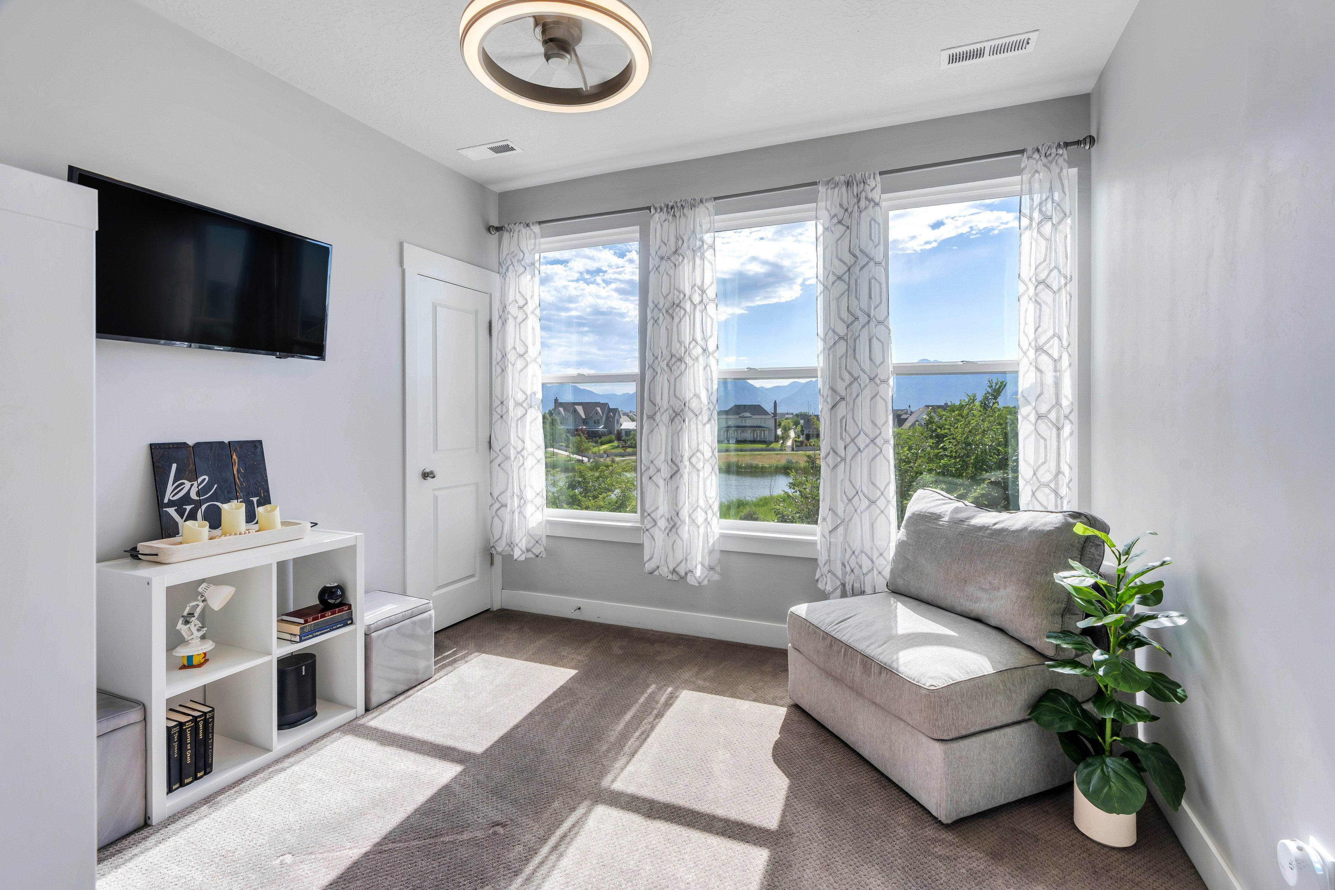 Room featuring three large windows with white trim