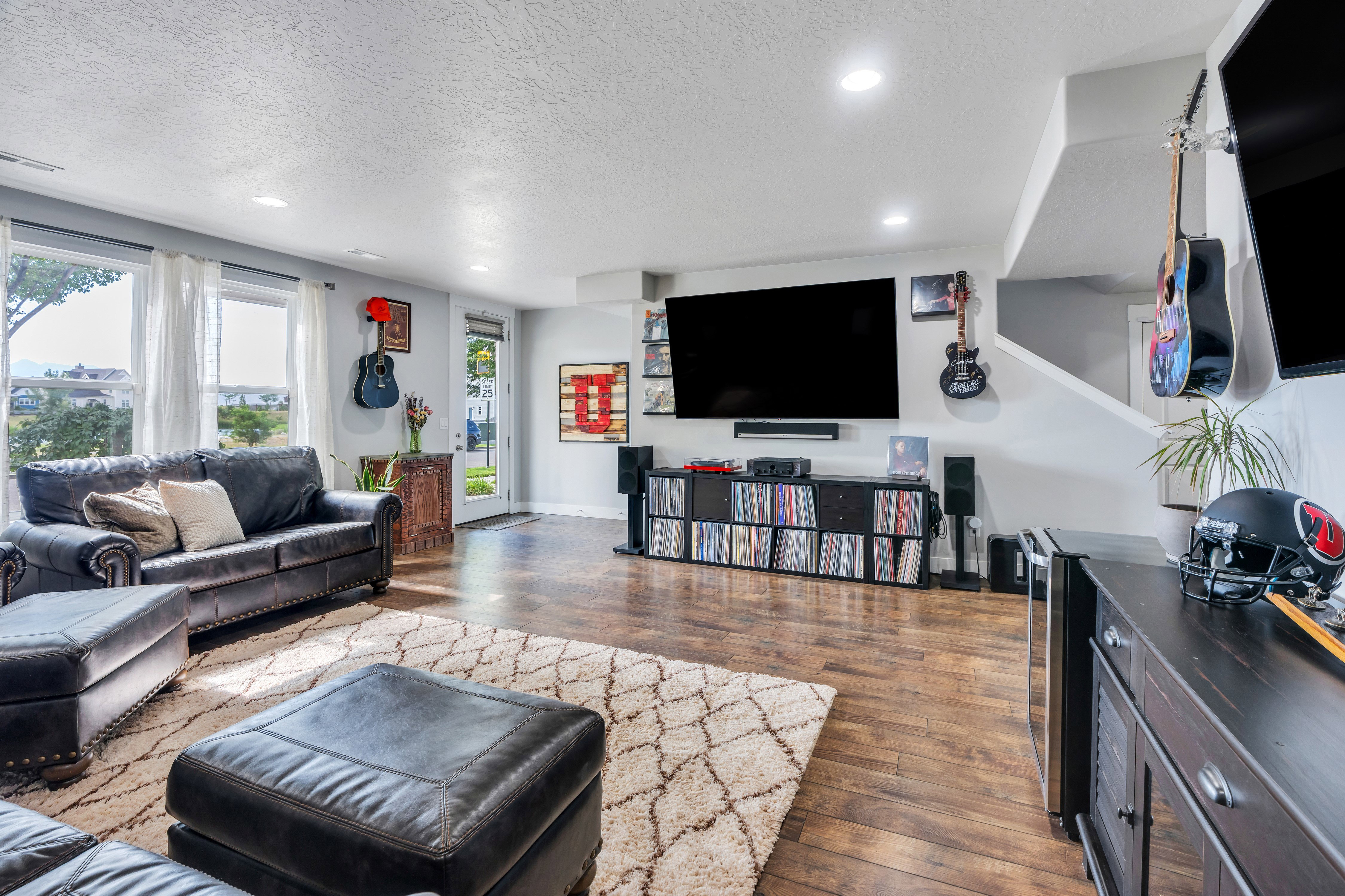 Open-concept living space featuring wood-finish flooring and recessed lighting