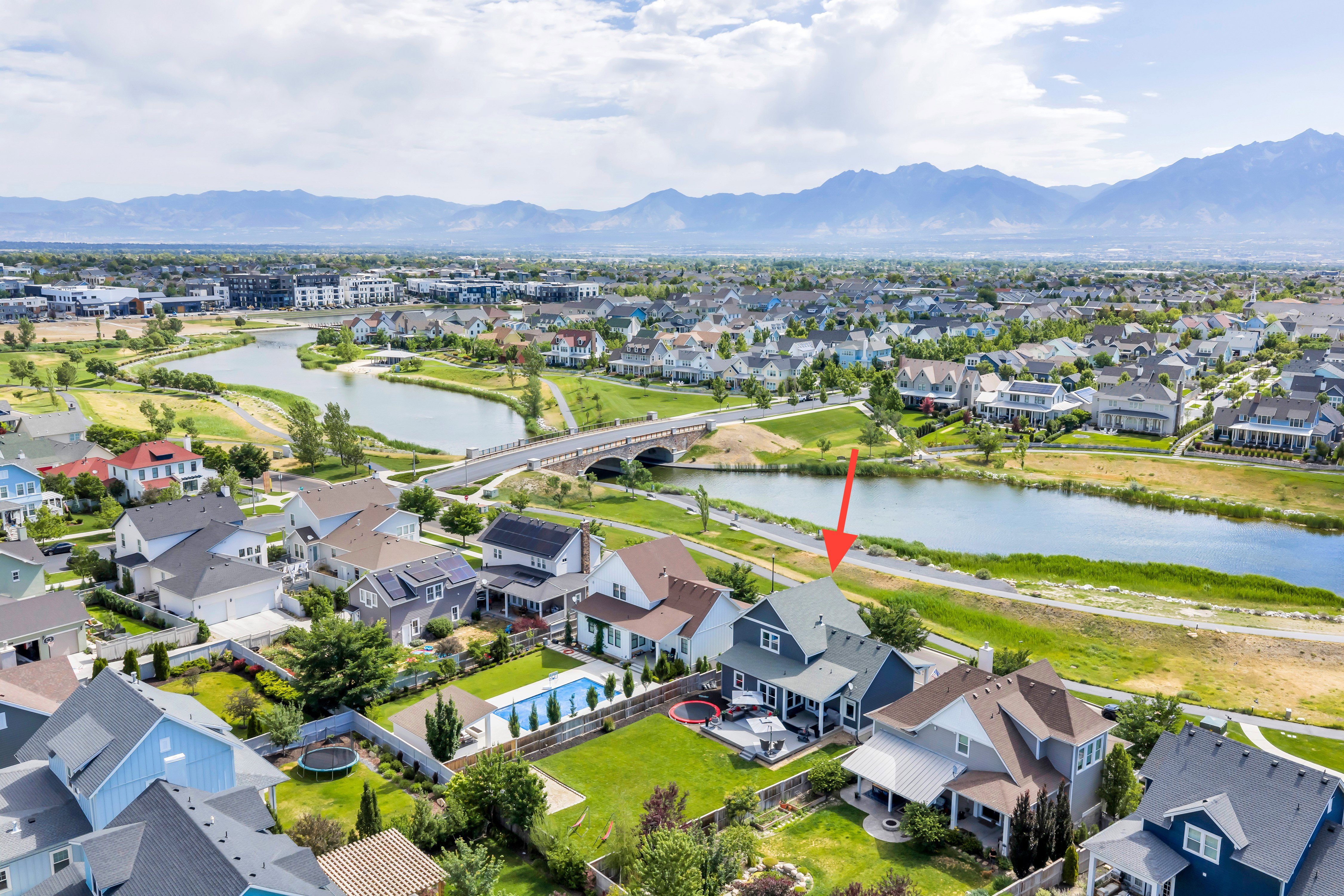 Expansive property featuring a private swimming pool, covered patio, green lawn space, and a waterfront setting