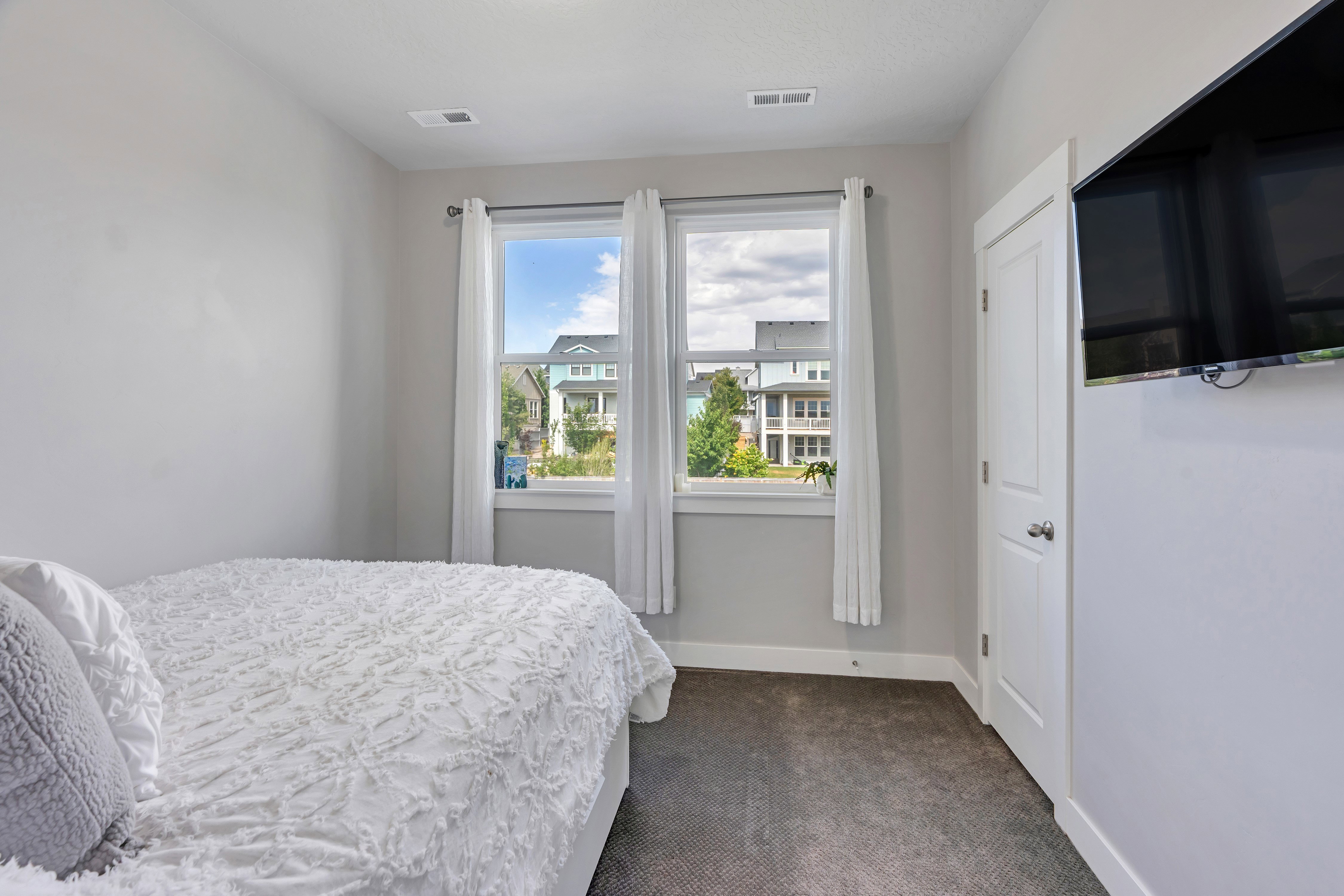 Bright interior space featuring two large windows with white trim