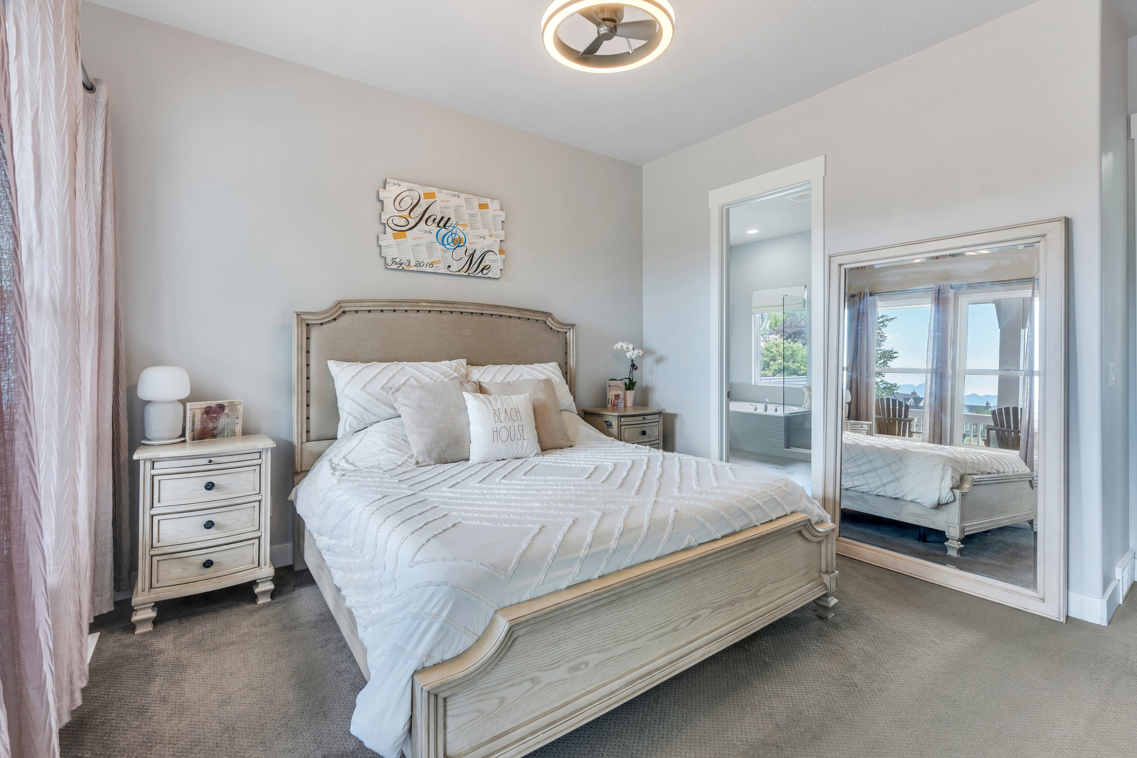 Carpeted bedroom with neutral wall tones and a contemporary ceiling fixture