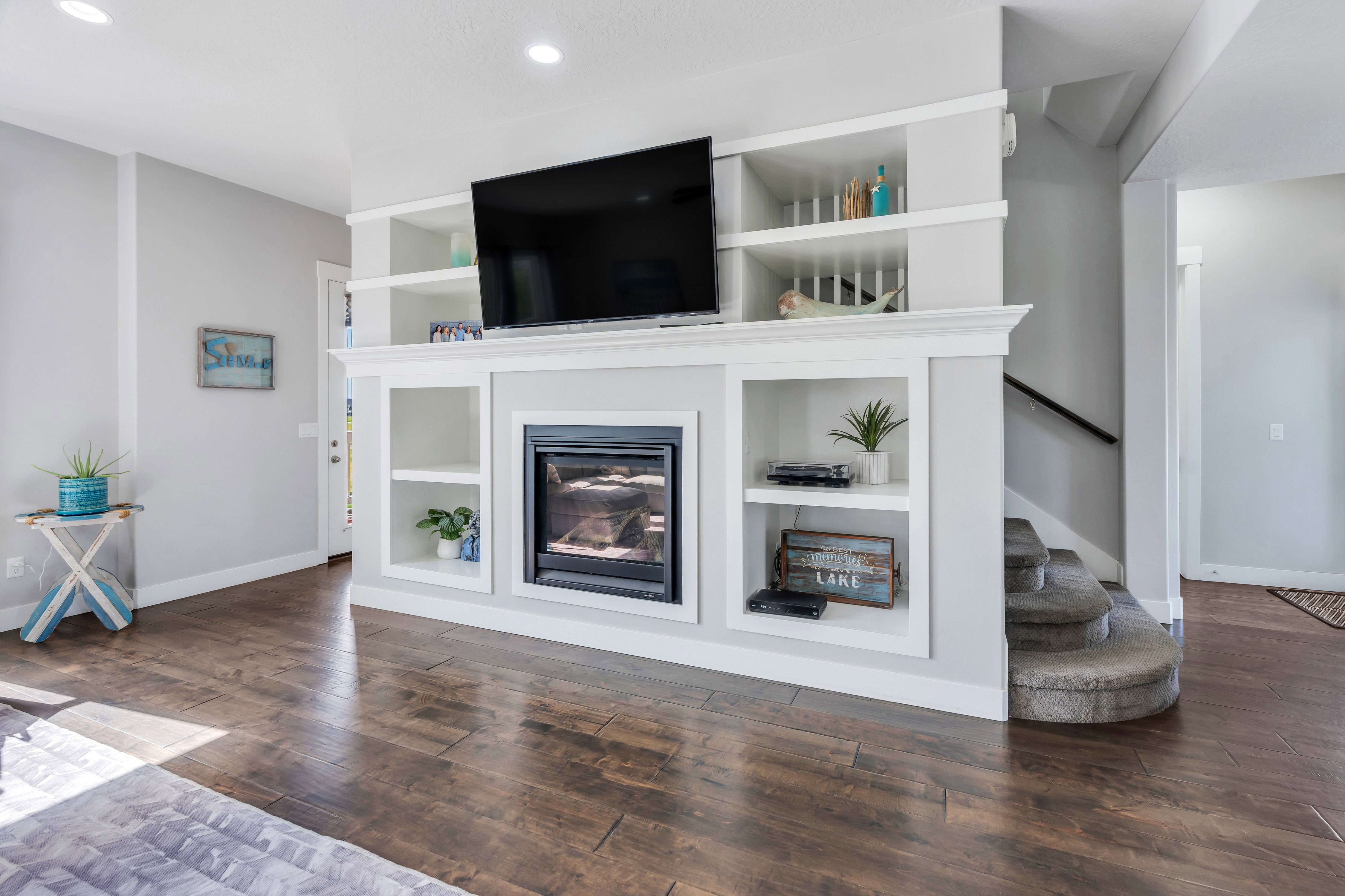Integrated fireplace unit featuring a contemporary insert, built-in shelving, and a mantle