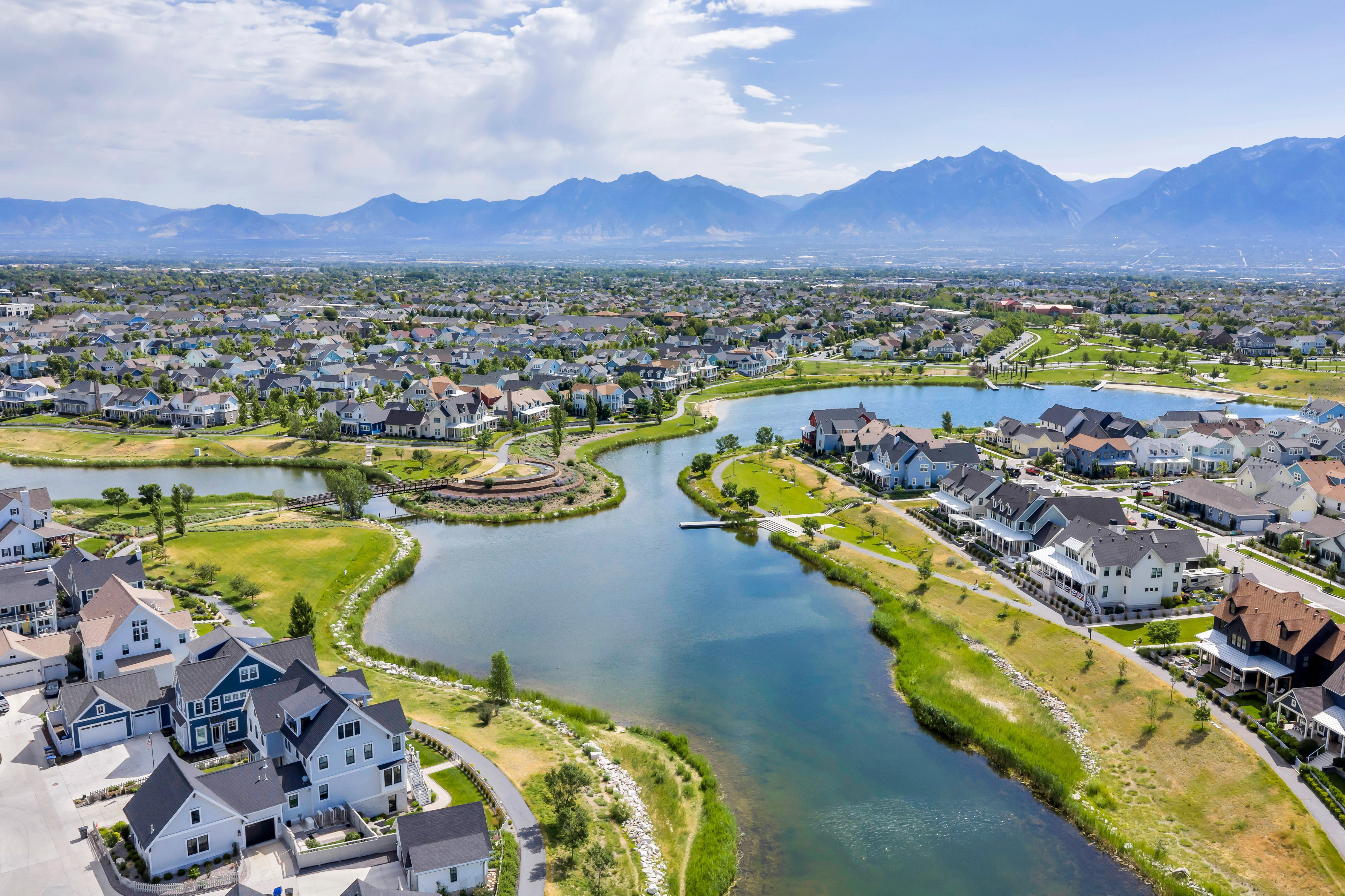 Aerial perspective showcasing a residential community with a prominent lake feature