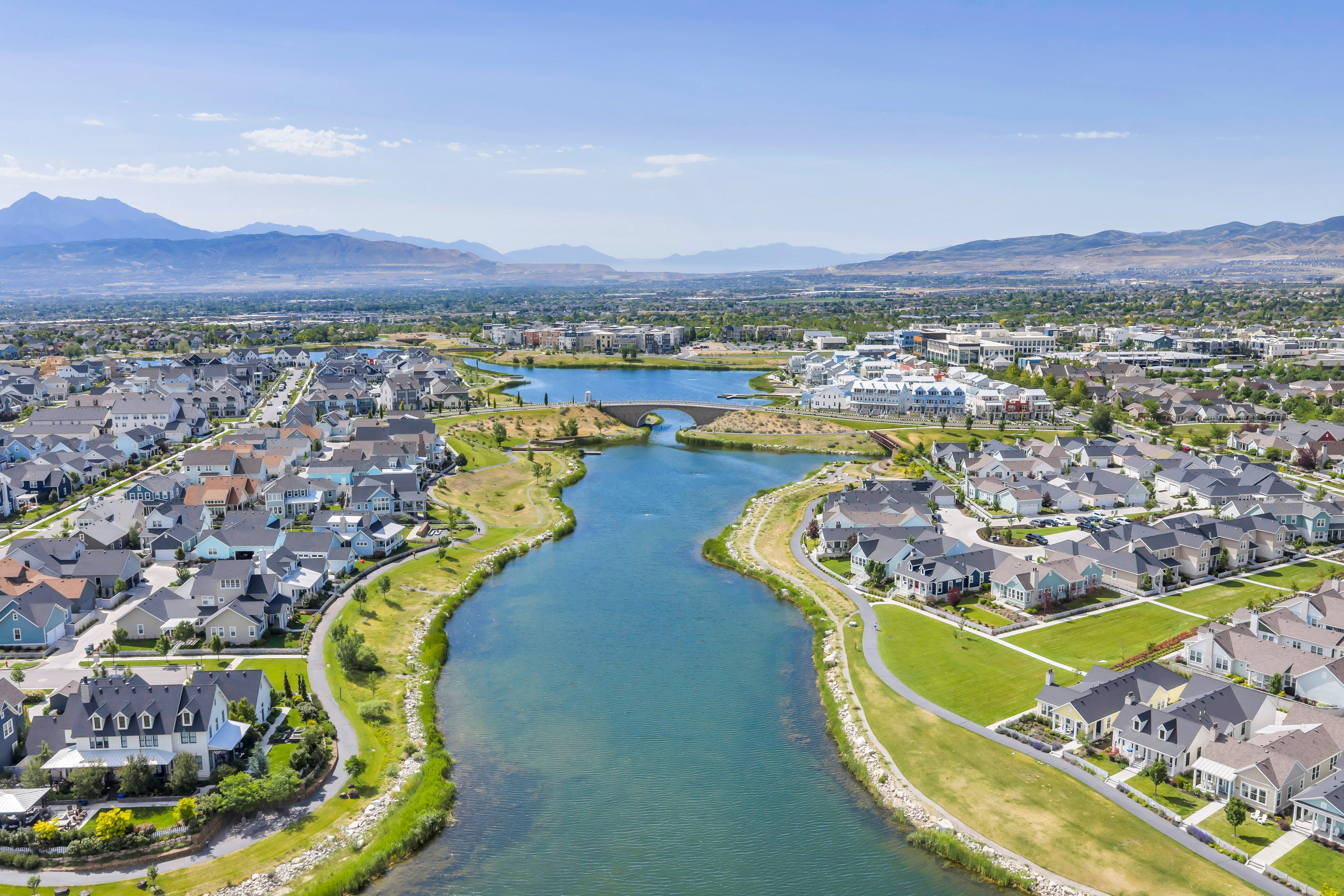 Expansive aerial perspective showcasing a master-planned community with a central lake feature
