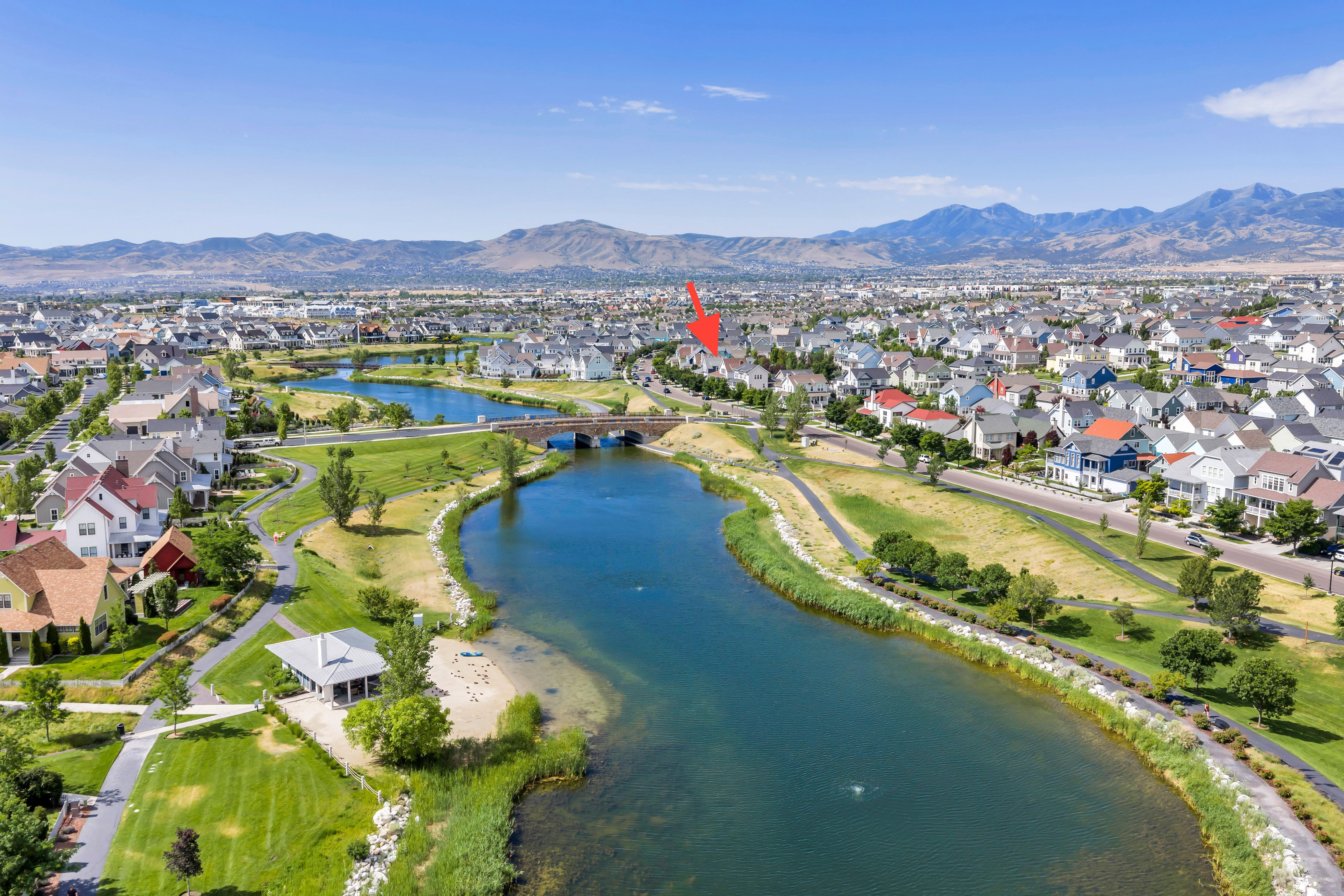 Expansive community featuring a large water body, surrounding green spaces, and a network of paved paths