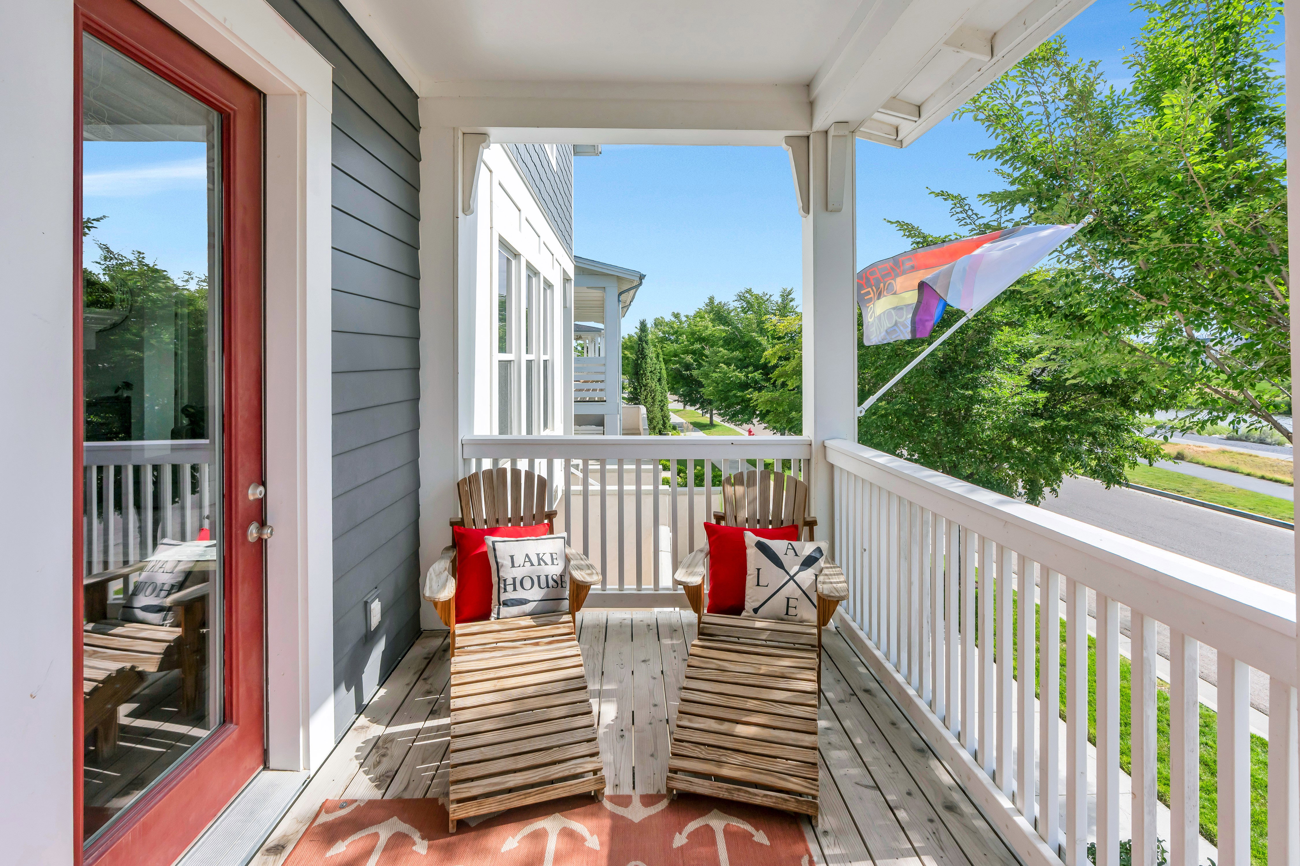 Covered porch featuring white columns and railing