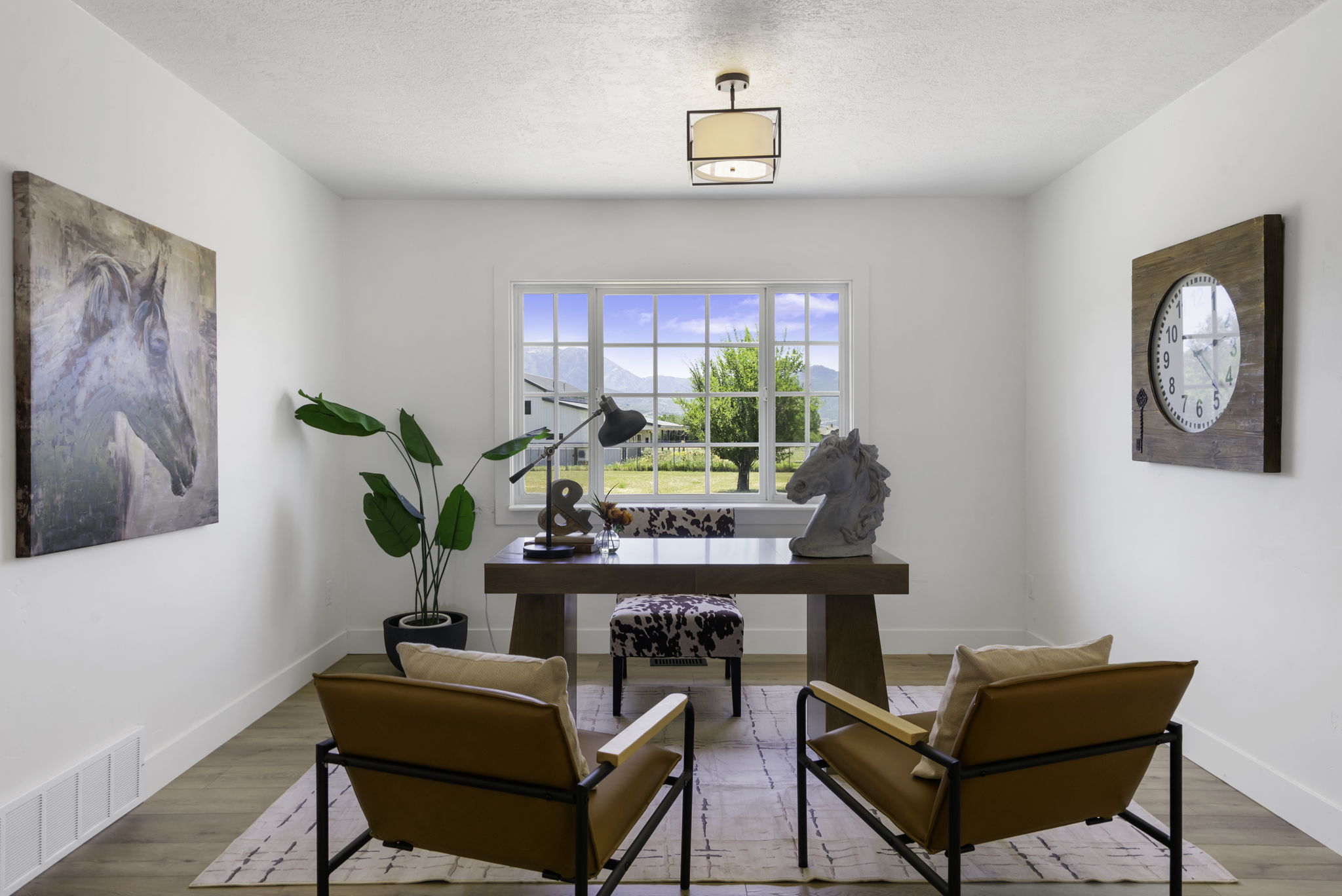Spacious room with wood-finish flooring and a large multi-pane window