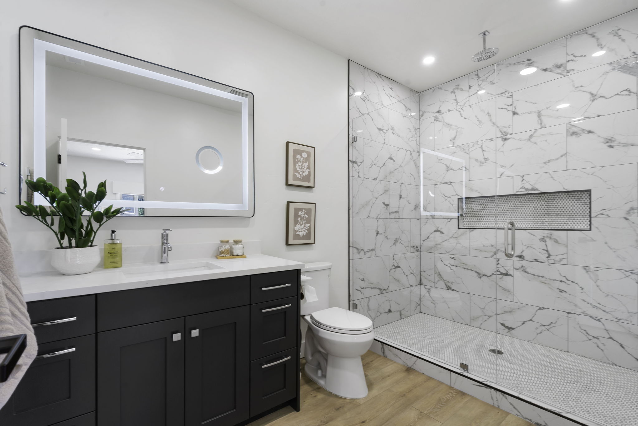 Bathroom featuring a spacious walk-in shower with large format tile and a recessed niche