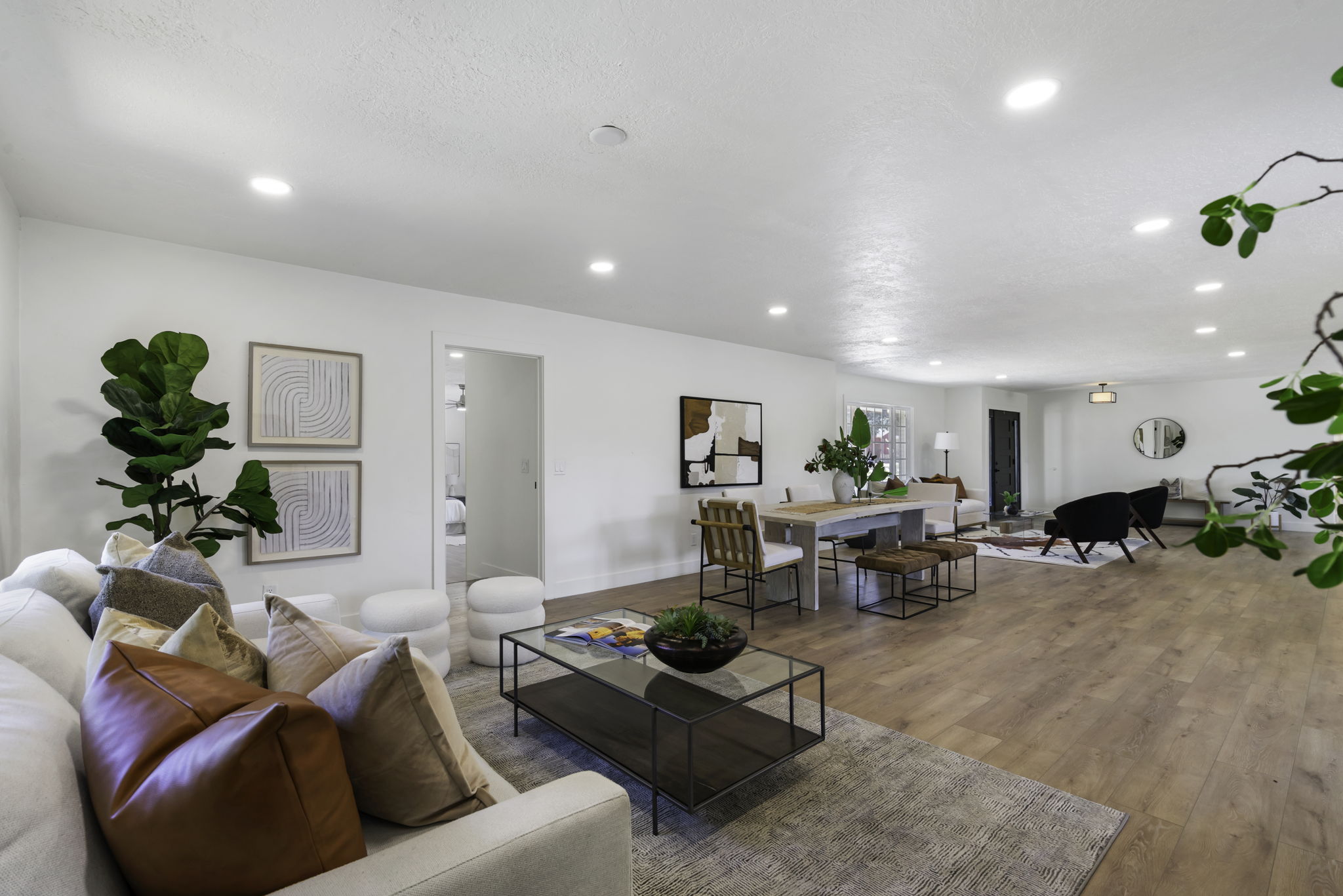 Spacious interior featuring wood-finish flooring, recessed lighting, and white walls