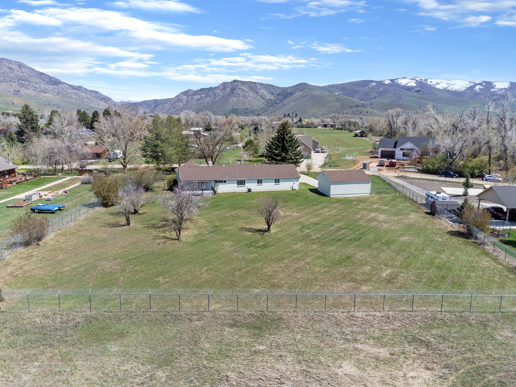 Expansive lot featuring a single-story residence and detached storage shed
