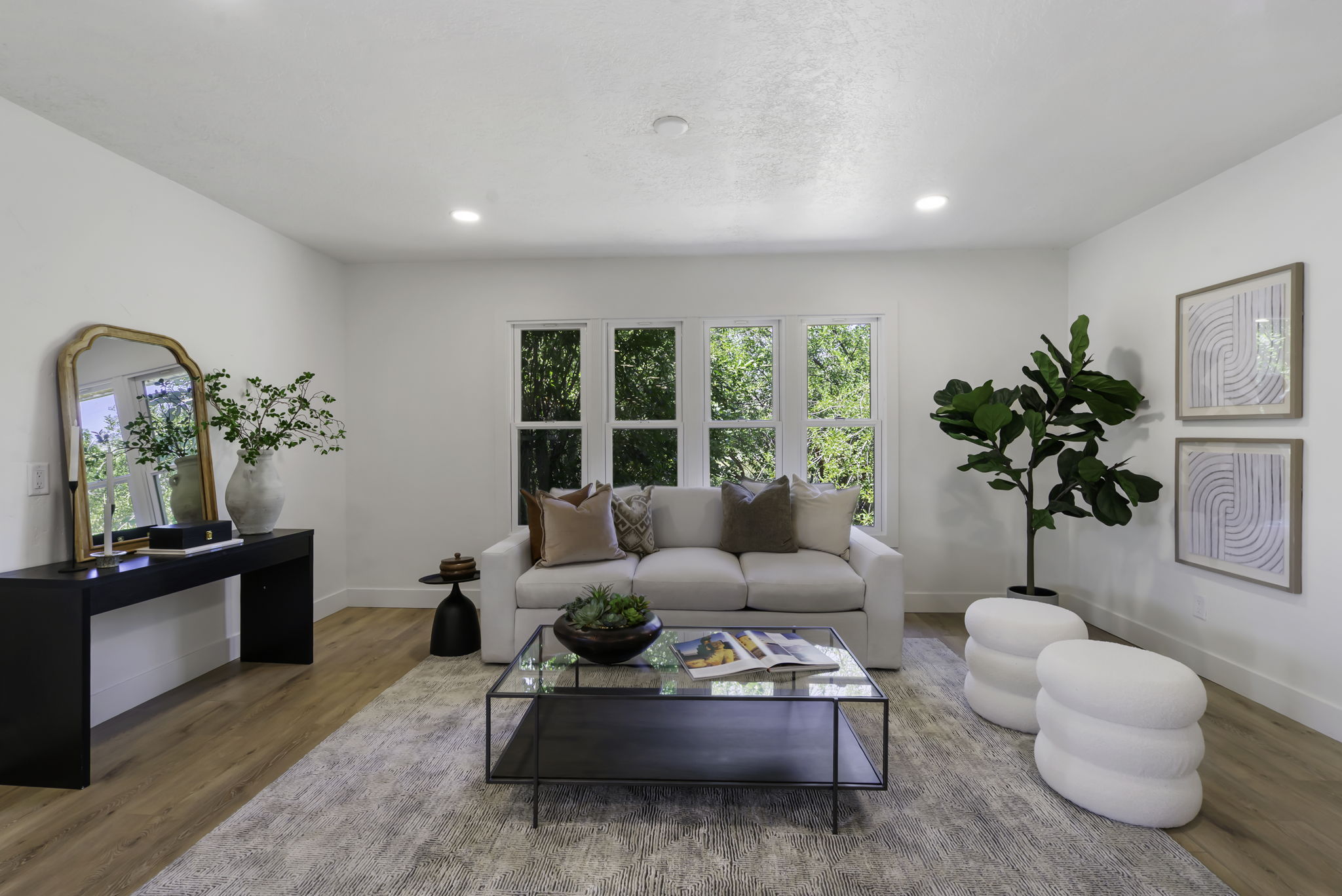 Living area featuring wood-finish flooring and recessed lighting
