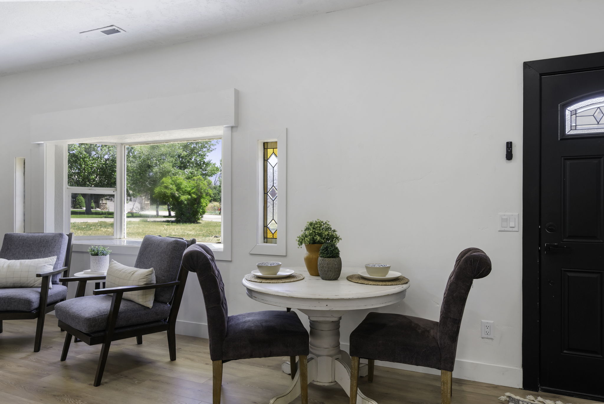 Bright living space featuring wood-finish flooring and a front-facing window