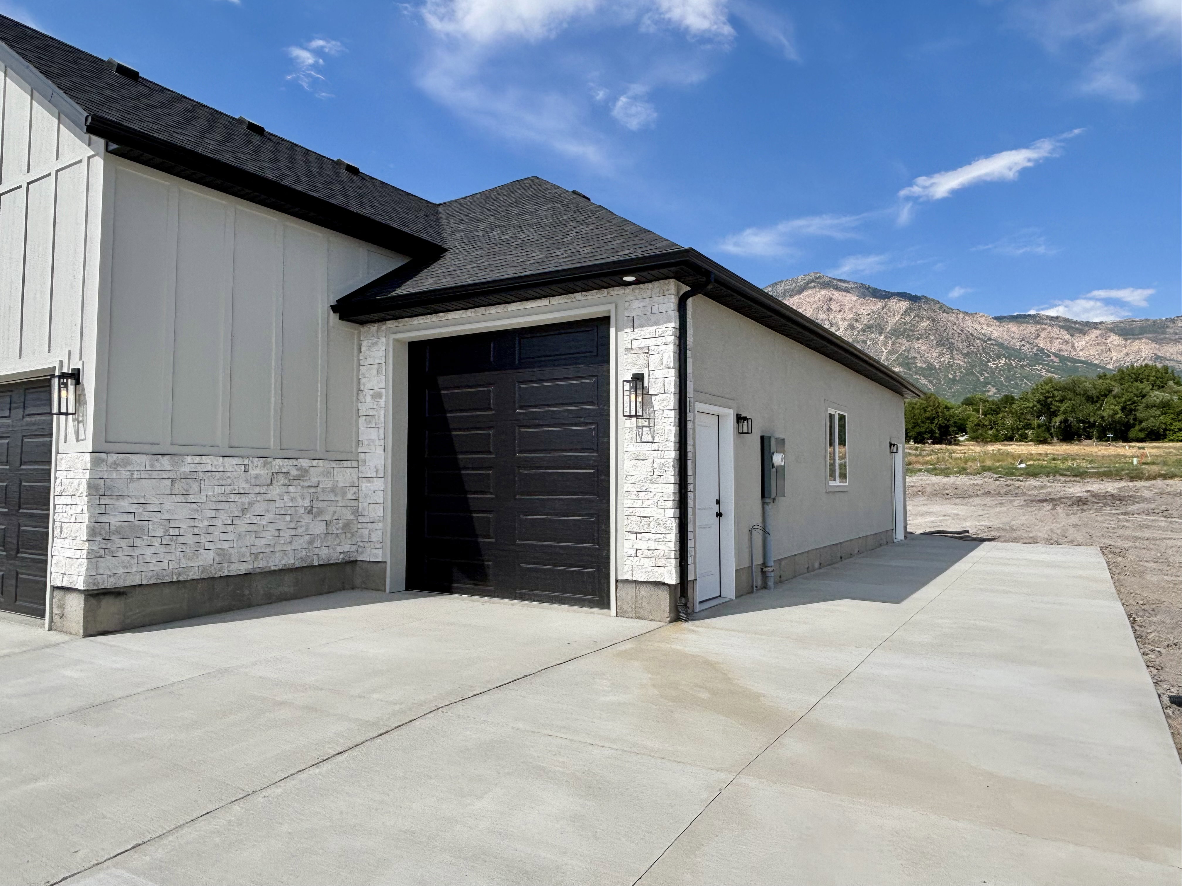 Large 3rd car garage - extra height, man door located on the side of the garage. Large extended RV to the side