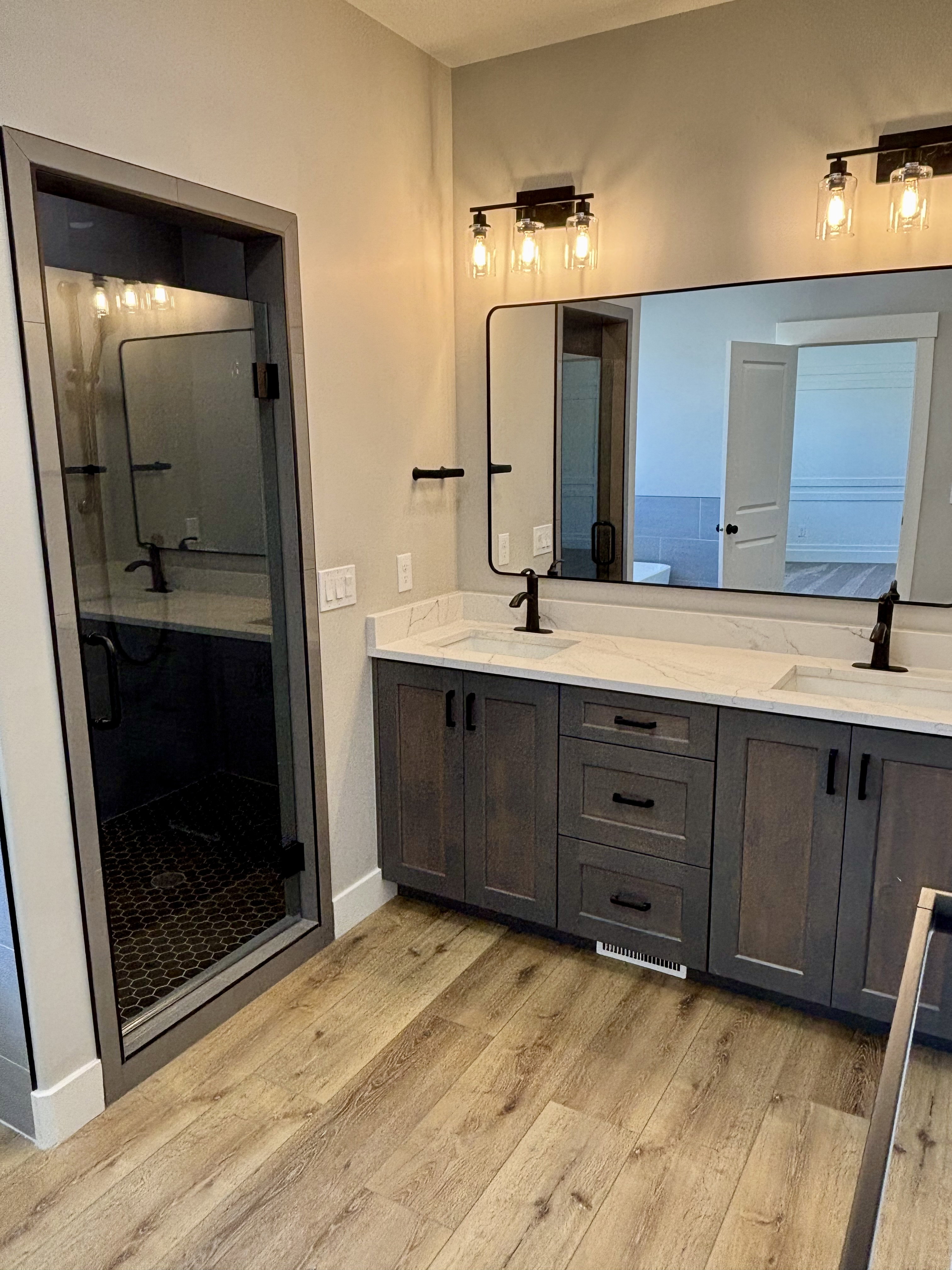 Master bath, with dual vanity with quartz countertops and undermount sinks.