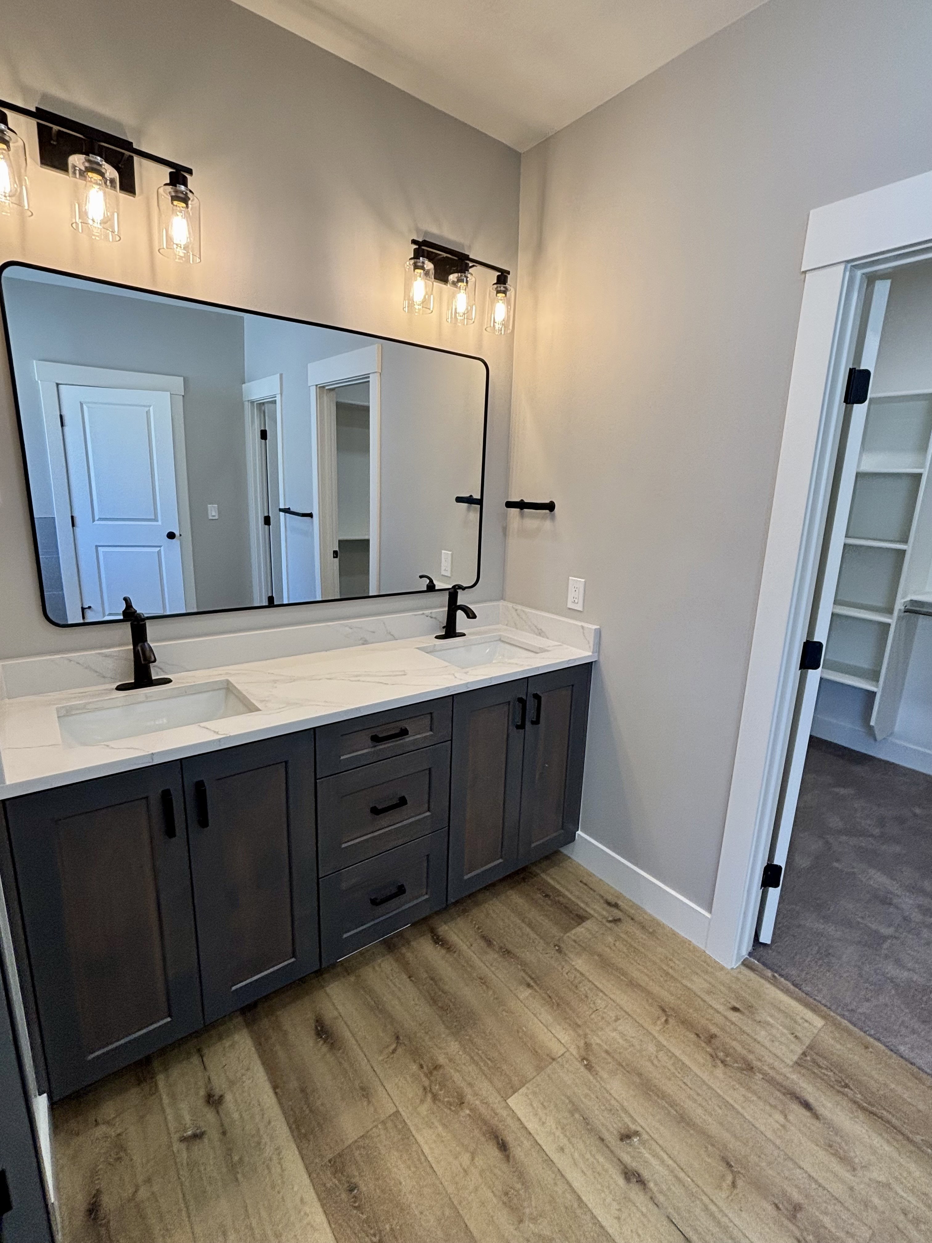 Master bath, with dual vanity with quartz countertops and undermount sinks.