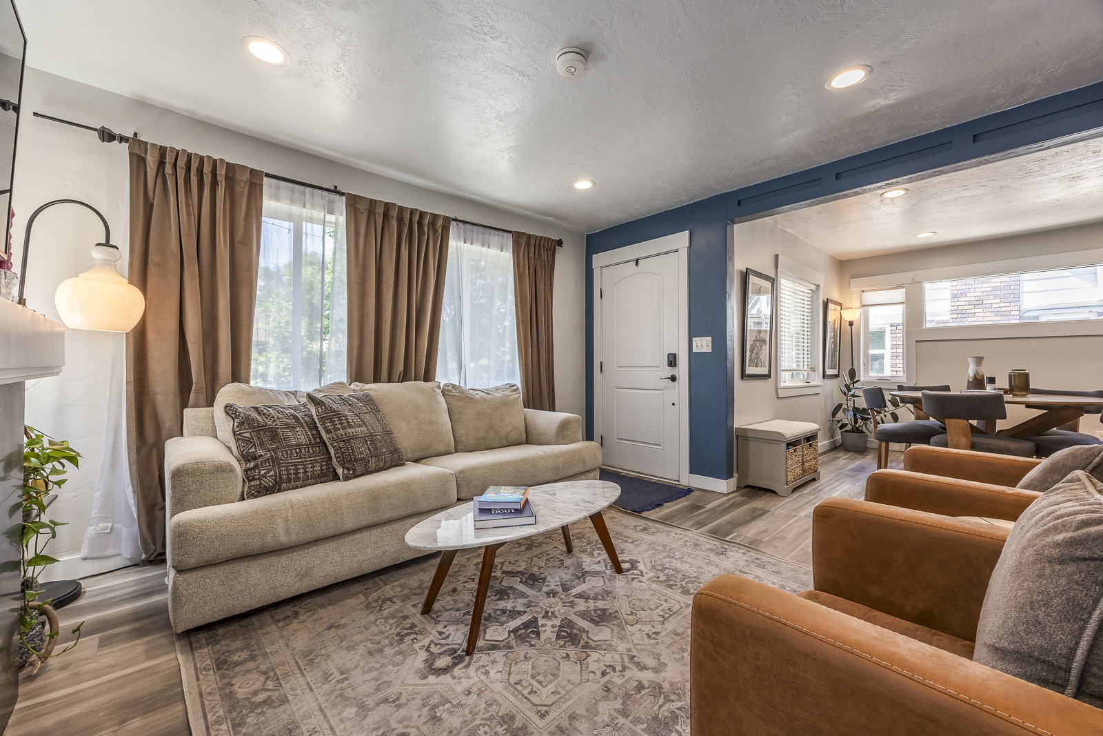 Bright living area featuring recessed lighting, wood-finish flooring, and a decorative fireplace