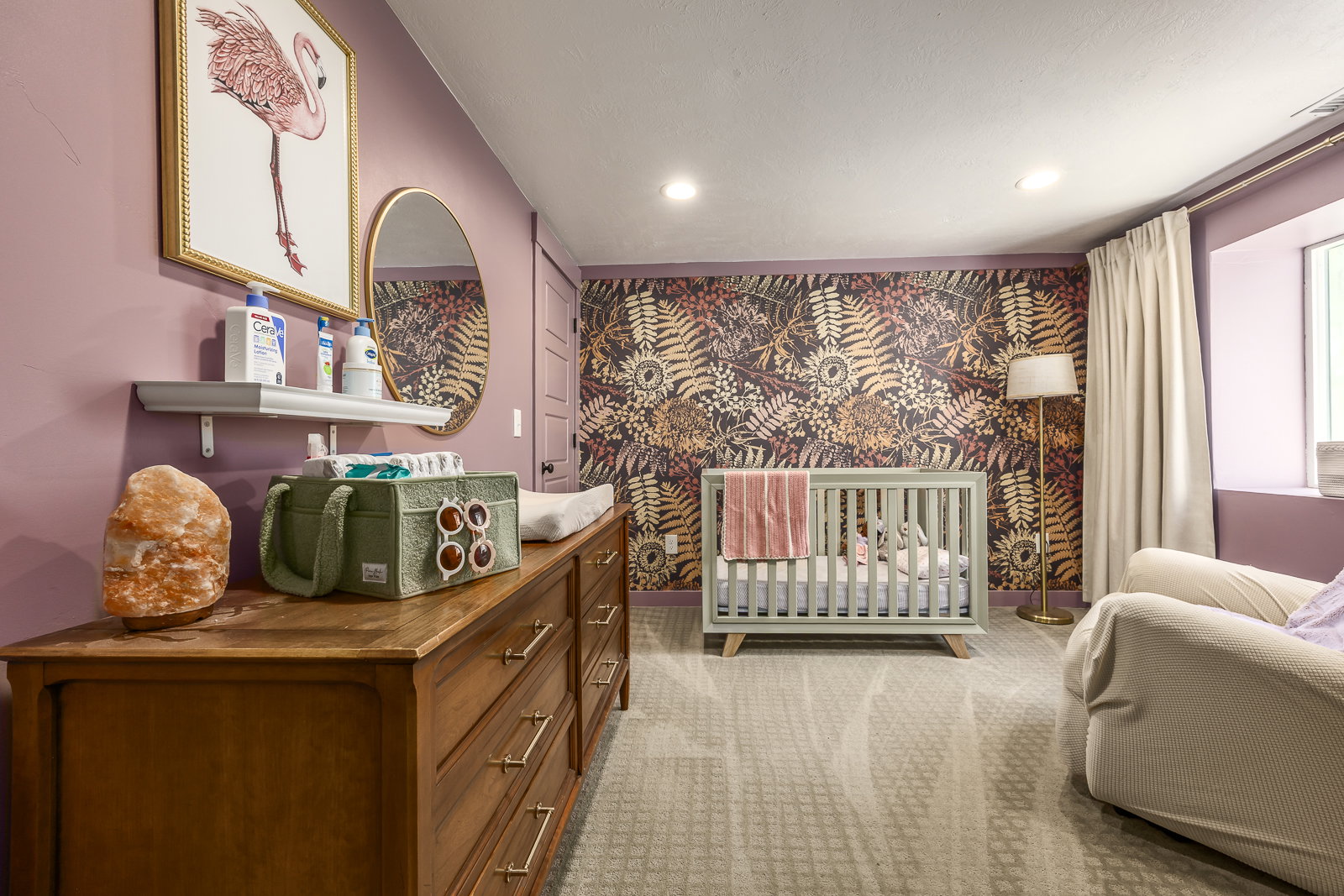 Room featuring a decorative accent wall, light-colored carpeting, recessed lighting, and a window with drapes