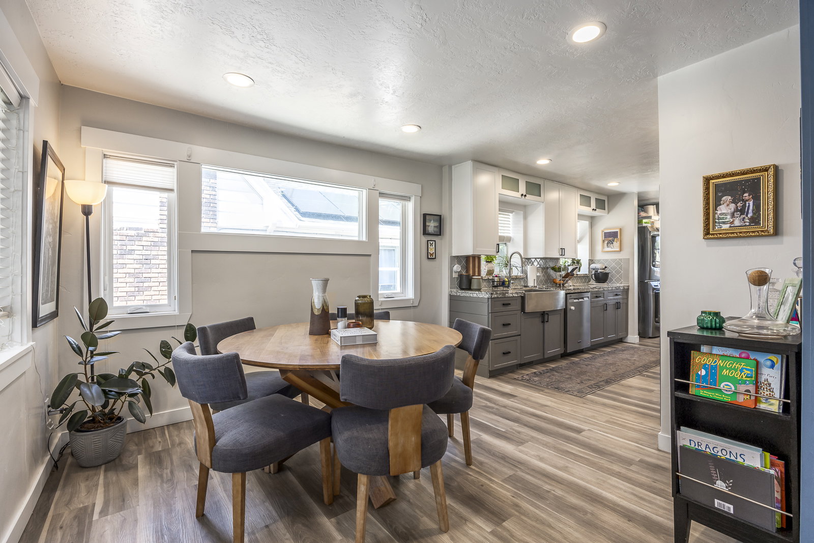 Open-concept living space featuring wood-finish flooring, recessed lighting, and ample natural light from multiple windows