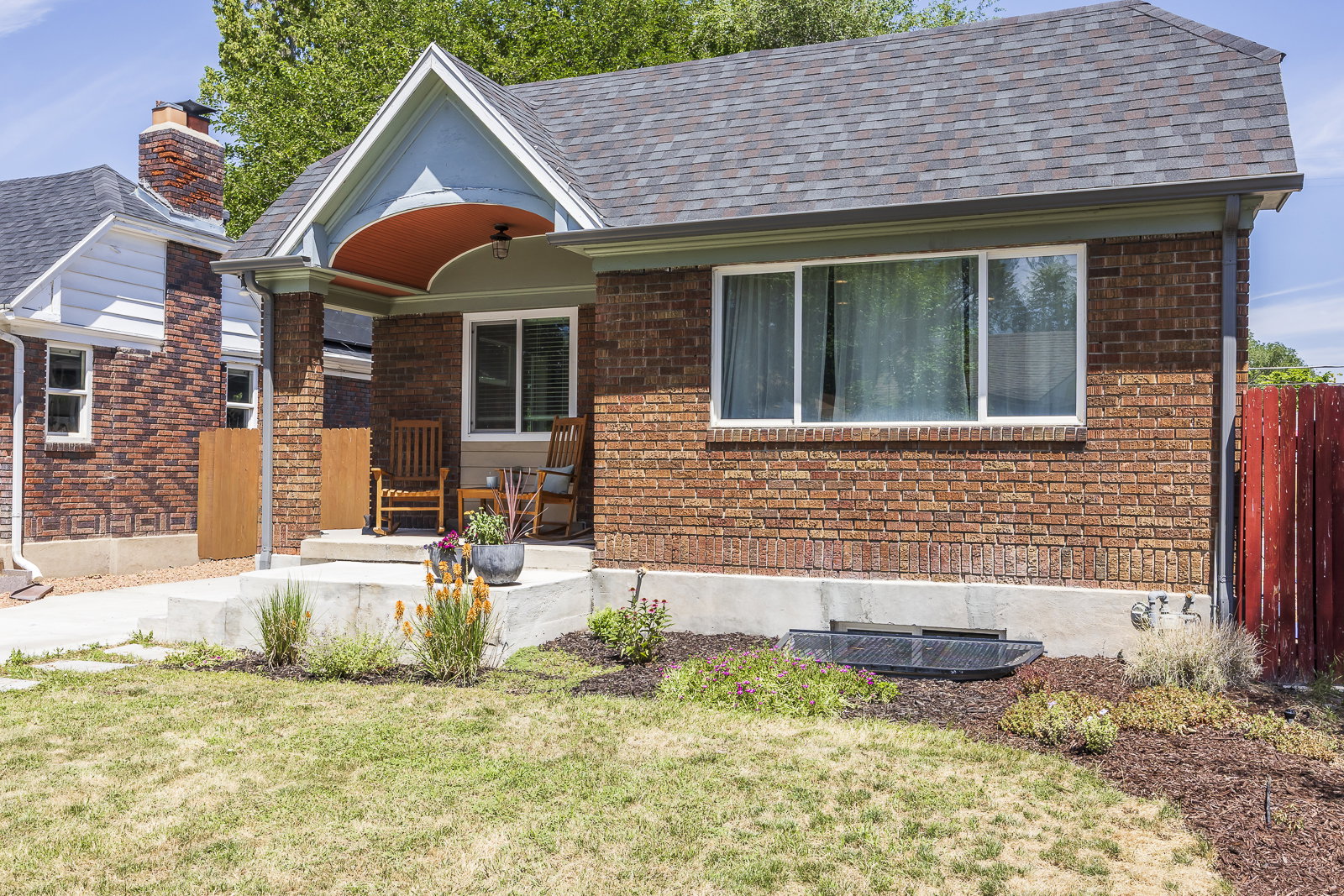 Brick exterior with an inviting covered porch and a gabled roofline