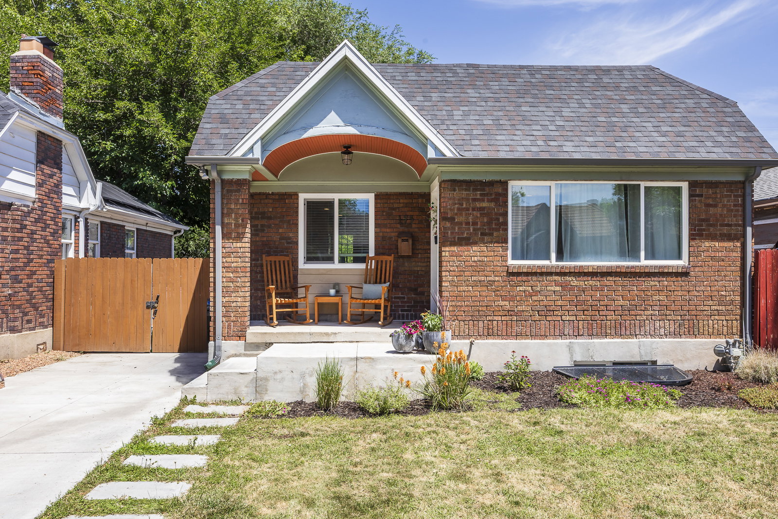 Brick exterior featuring an inviting covered porch