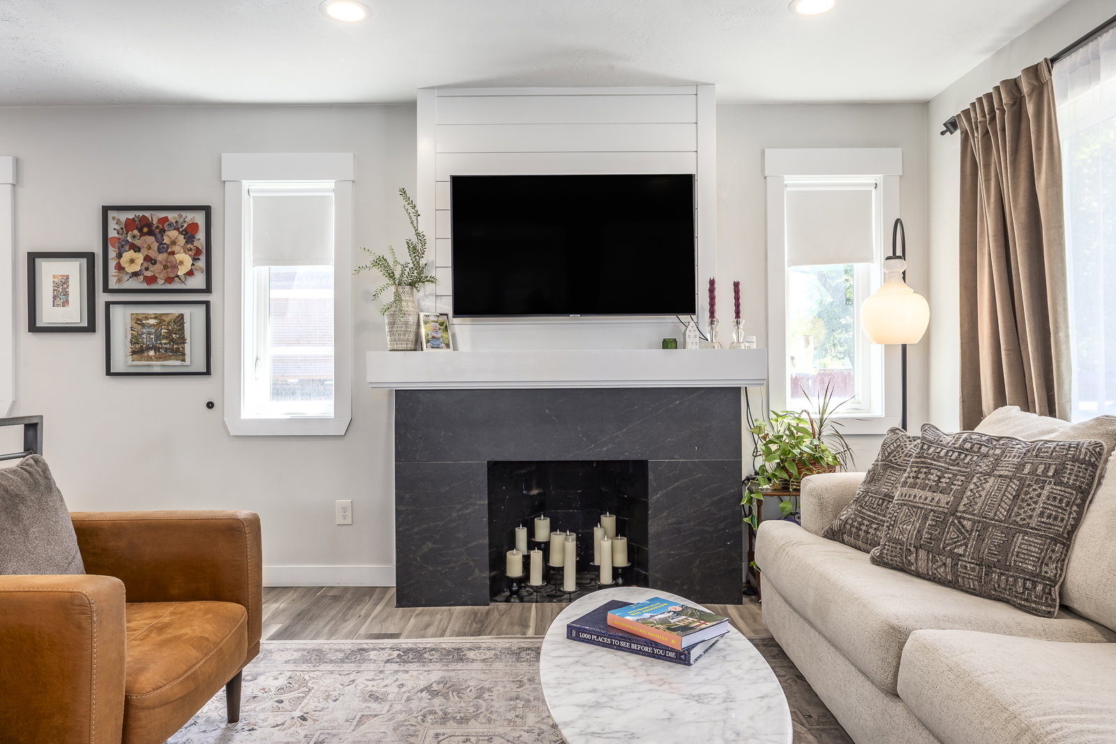 Living area featuring a modern fireplace with a dark stone surround and white mantel