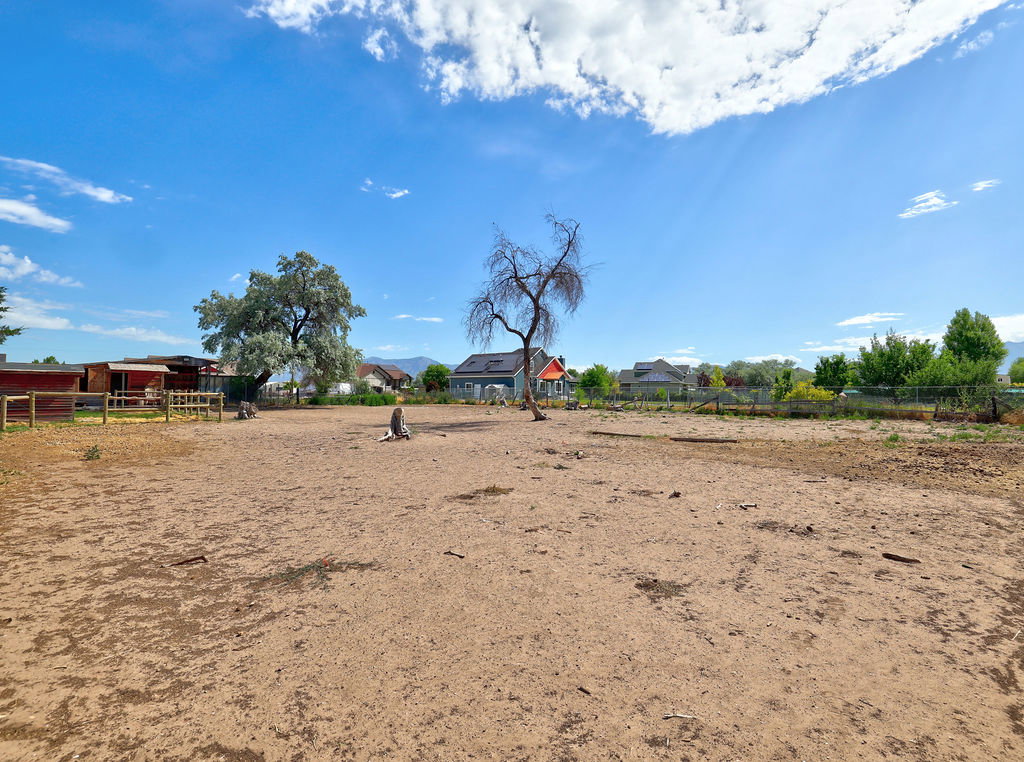 Expansive lot featuring open land, mature trees, and existing fencing